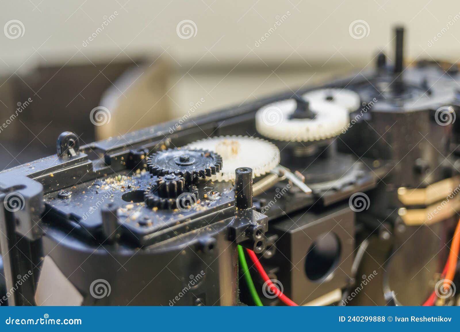 A Group of Gears of a Compact Camera To Be Repaired. Cleaning the Gears