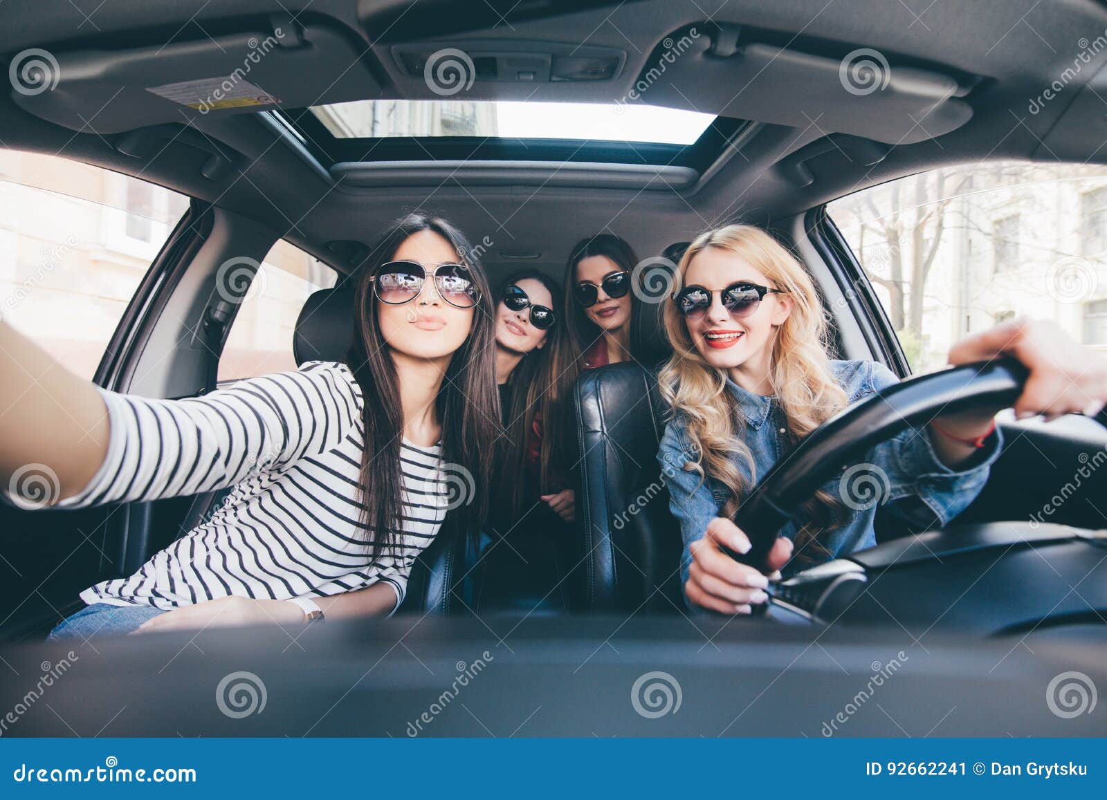 Group Of Girls Having Fun In The Car And Taking Selfies