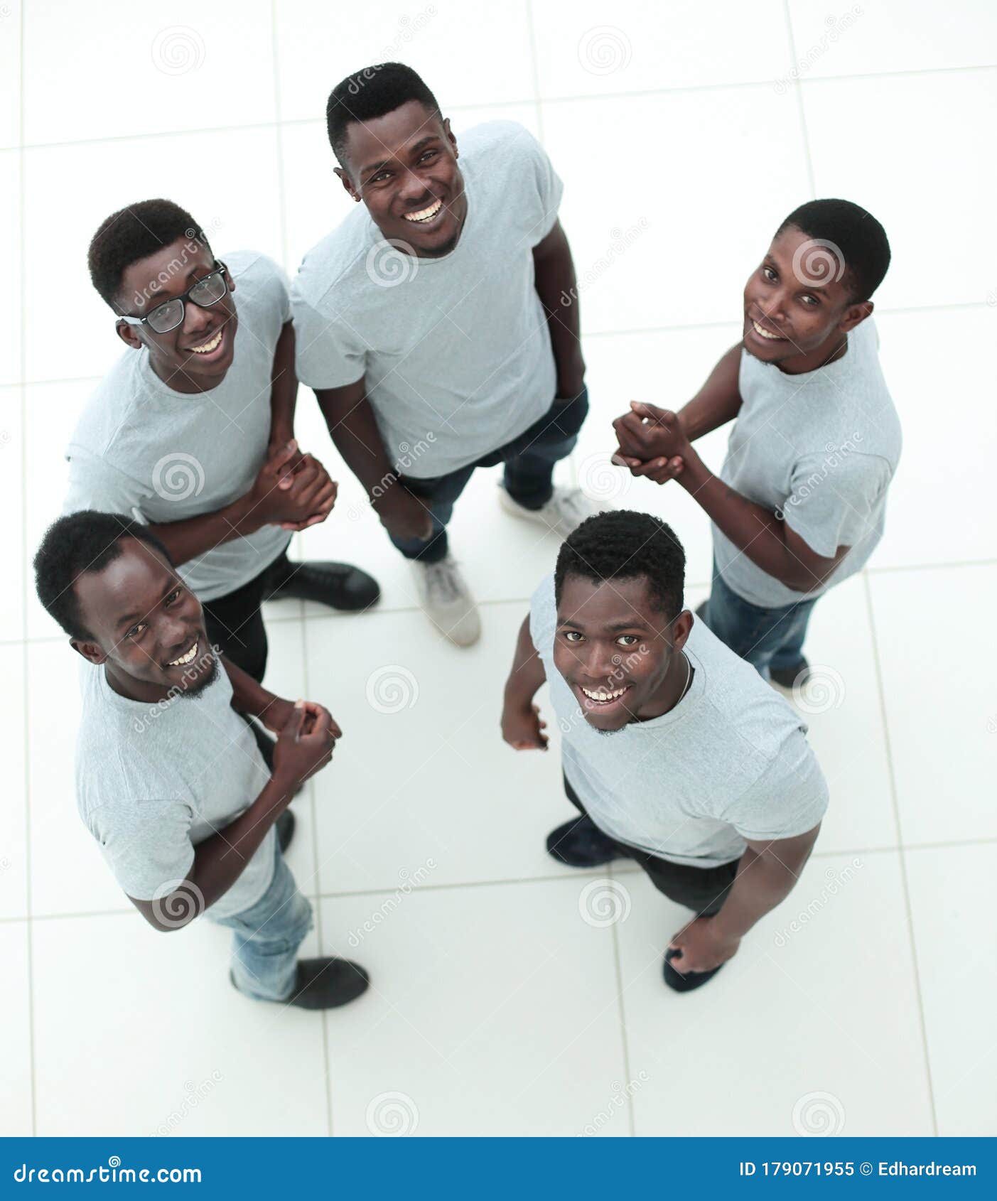 Group of Guys Standing in a Circle and Looking at the Camera Stock