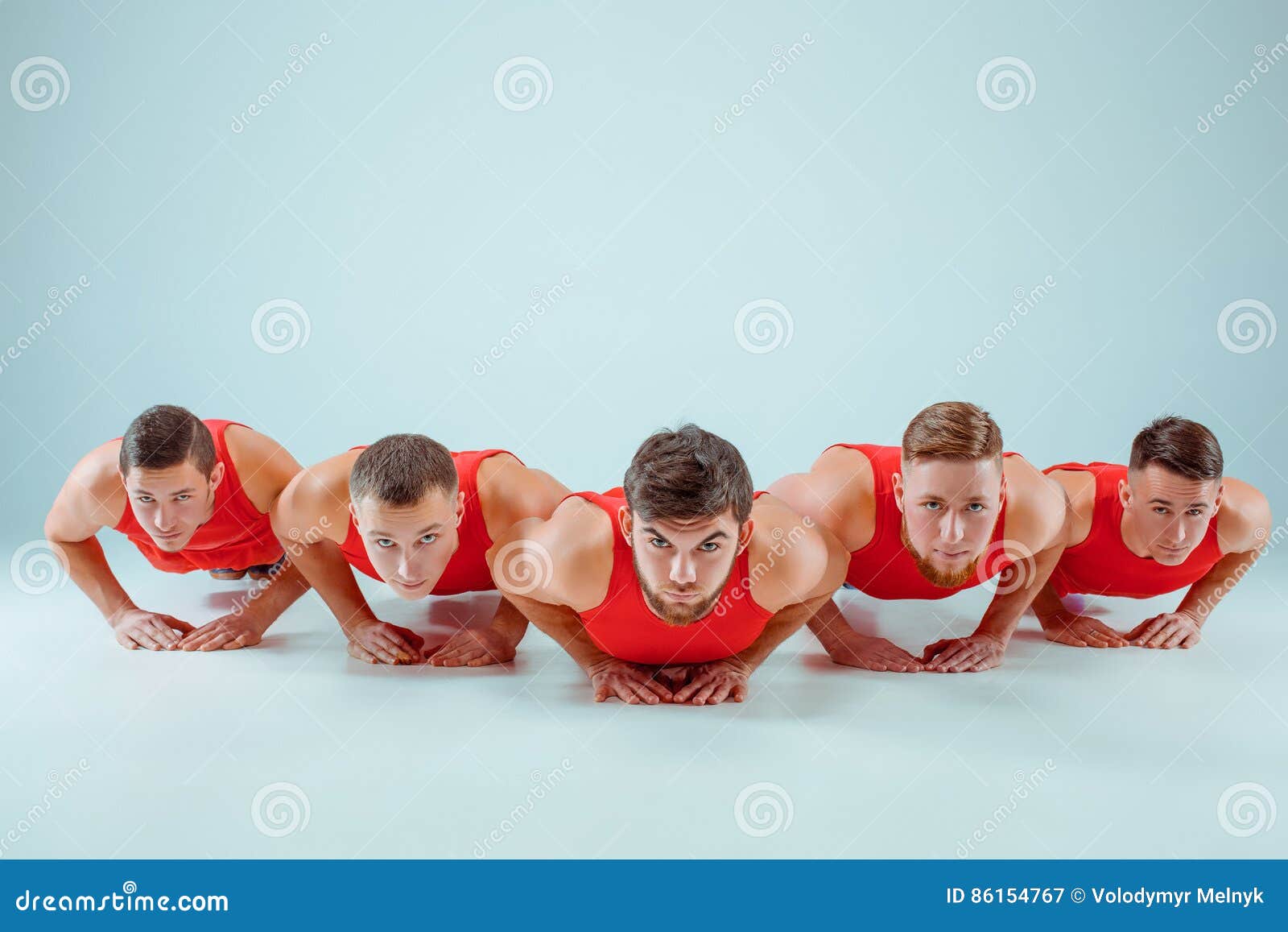 The Group of Gymnastic Acrobatic Caucasian Men on Balance Pose Stock