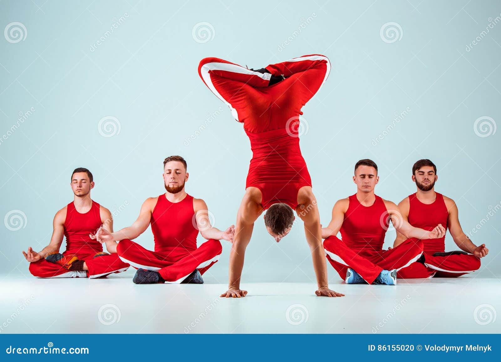 The Group of Gymnastic Acrobatic Caucasian Men on Balance Pose Stock