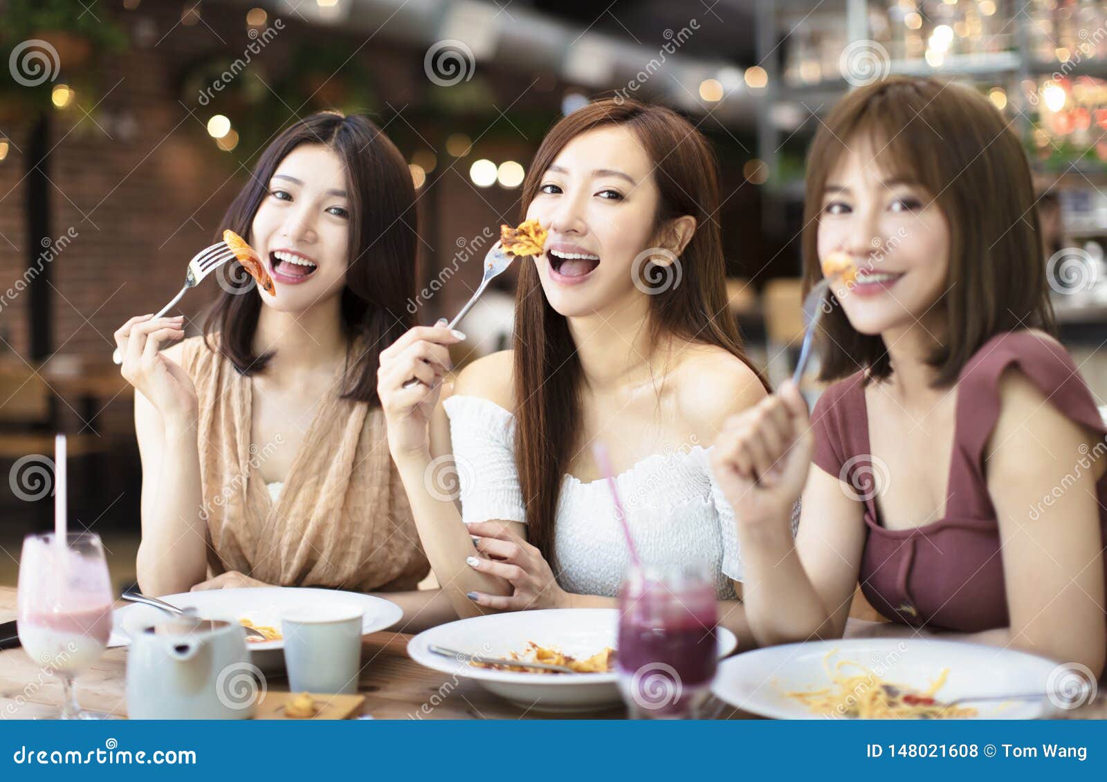 Happy Friends Having Dinner in the Restaurant Stock Photo - Image of