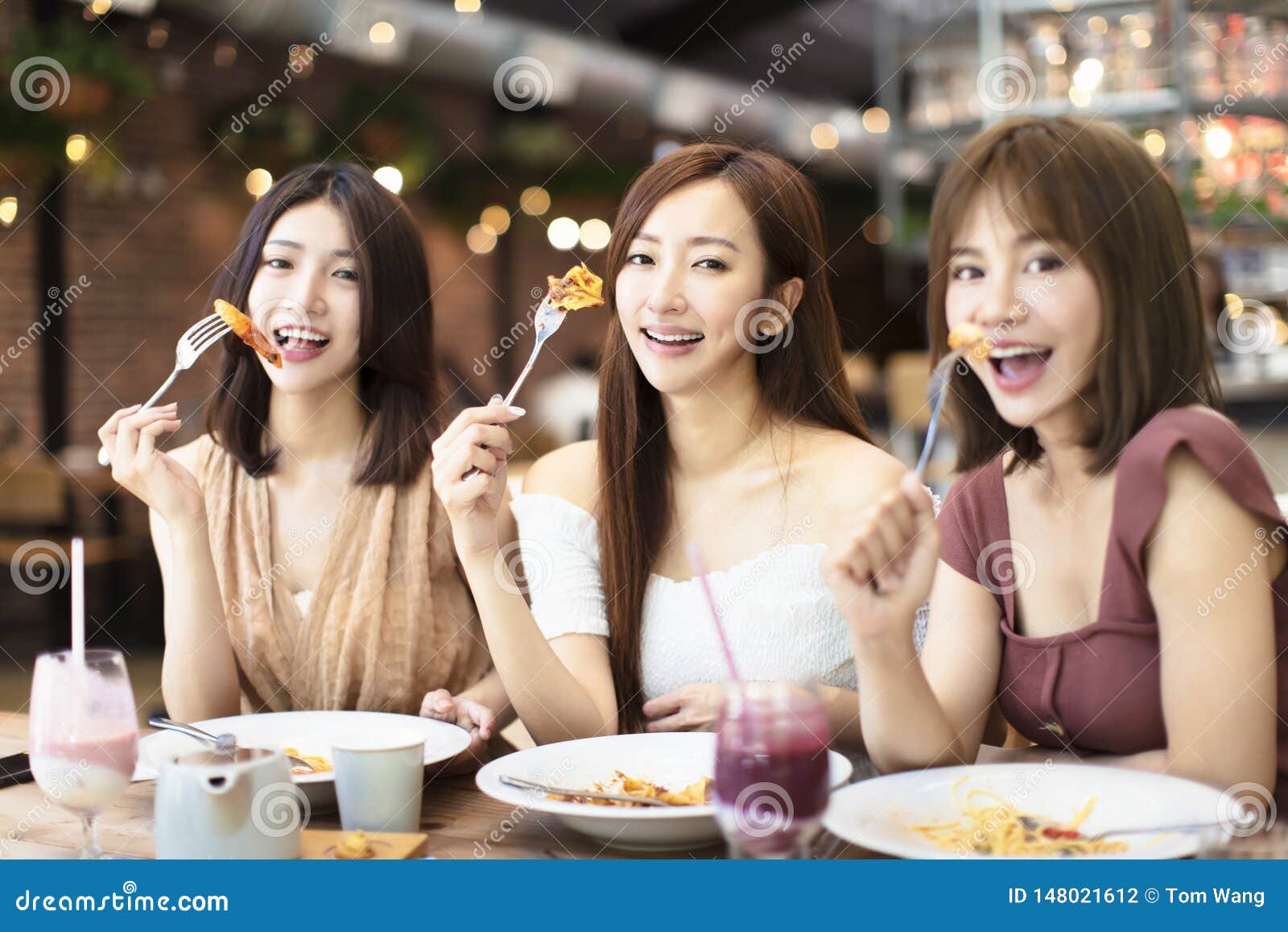 Happy Friends Having Dinner in the Restaurant Stock Photo - Image of