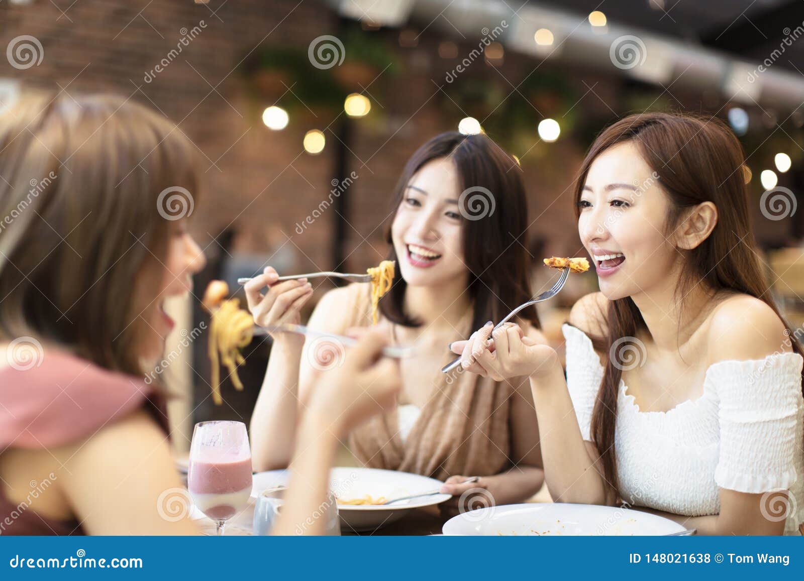 Happy Friends Having Dinner In The Restaurant Stock Photo - Image of