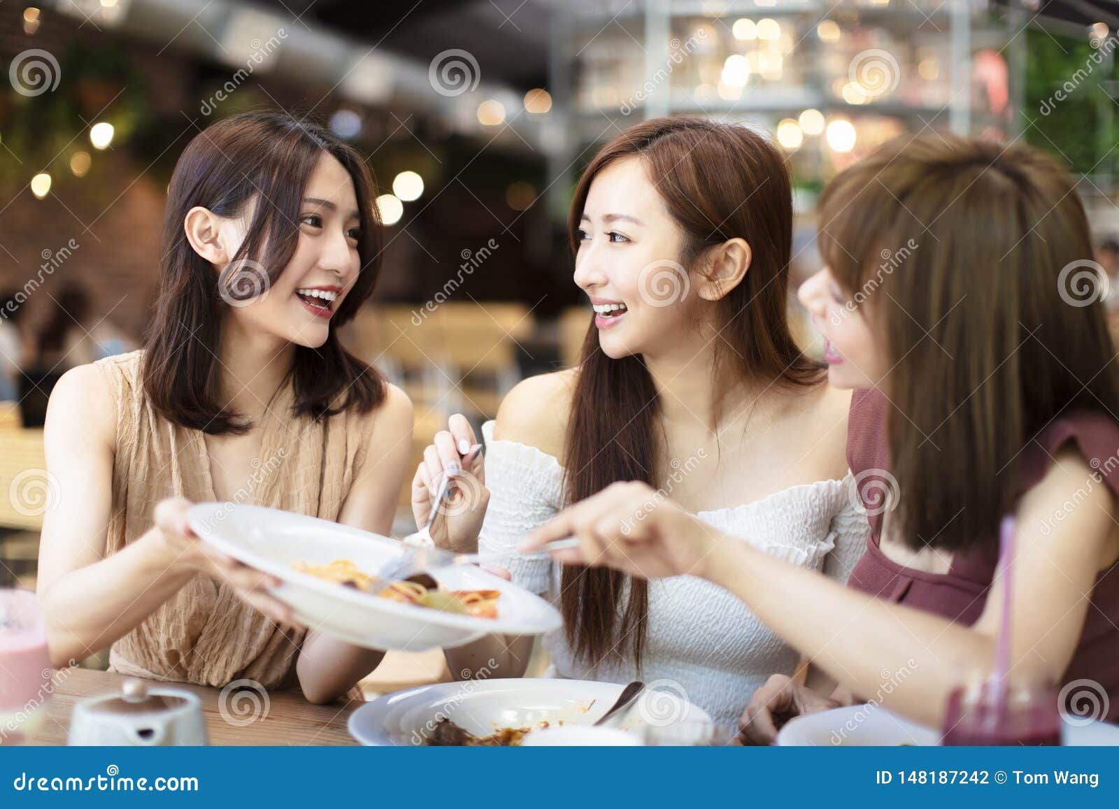 Happy Friends Having Dinner in the Restaurant Stock Photo - Image of