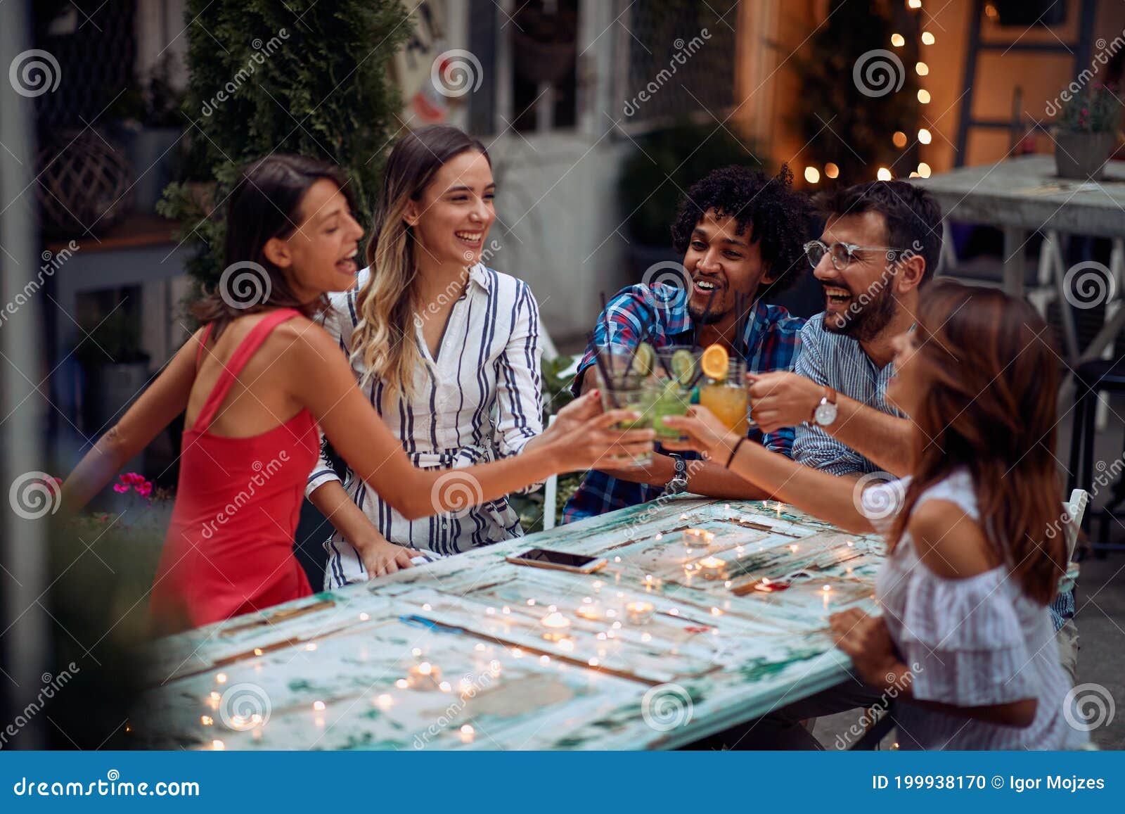 A Group of Happy Friends Having a Toast at the Open Air Birthday Party. Quality Friendship Time Together Stock Photo - of multiethnic, lovely: 199938170