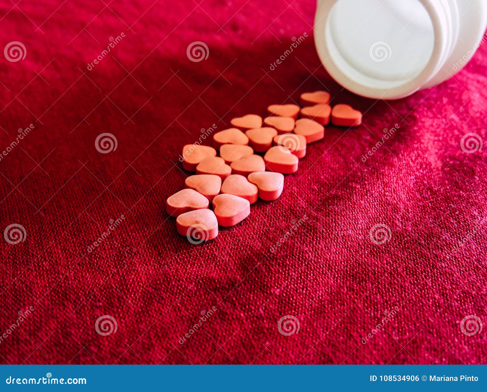 group of hearts pills in red cloth background. valentines day