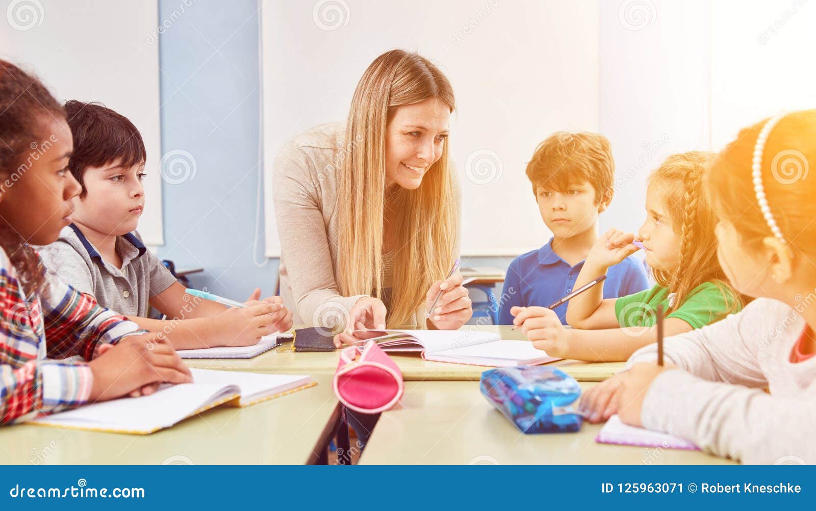 Group Of Kids Does Homework In Fulltime School Stock