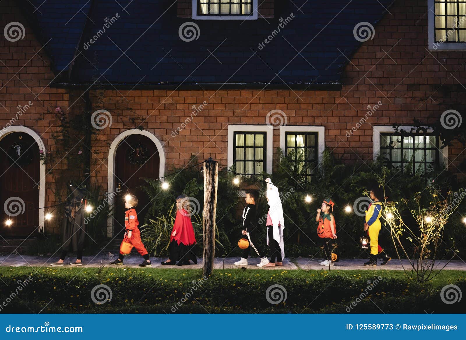 group of kids with halloween costumes walking to trick or treating