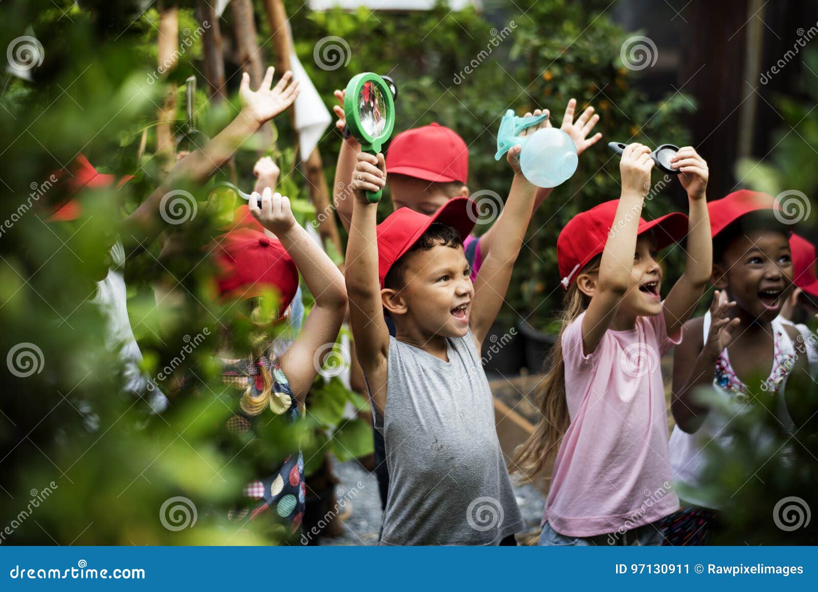 group of kindergarten kids learning gardening outdoors