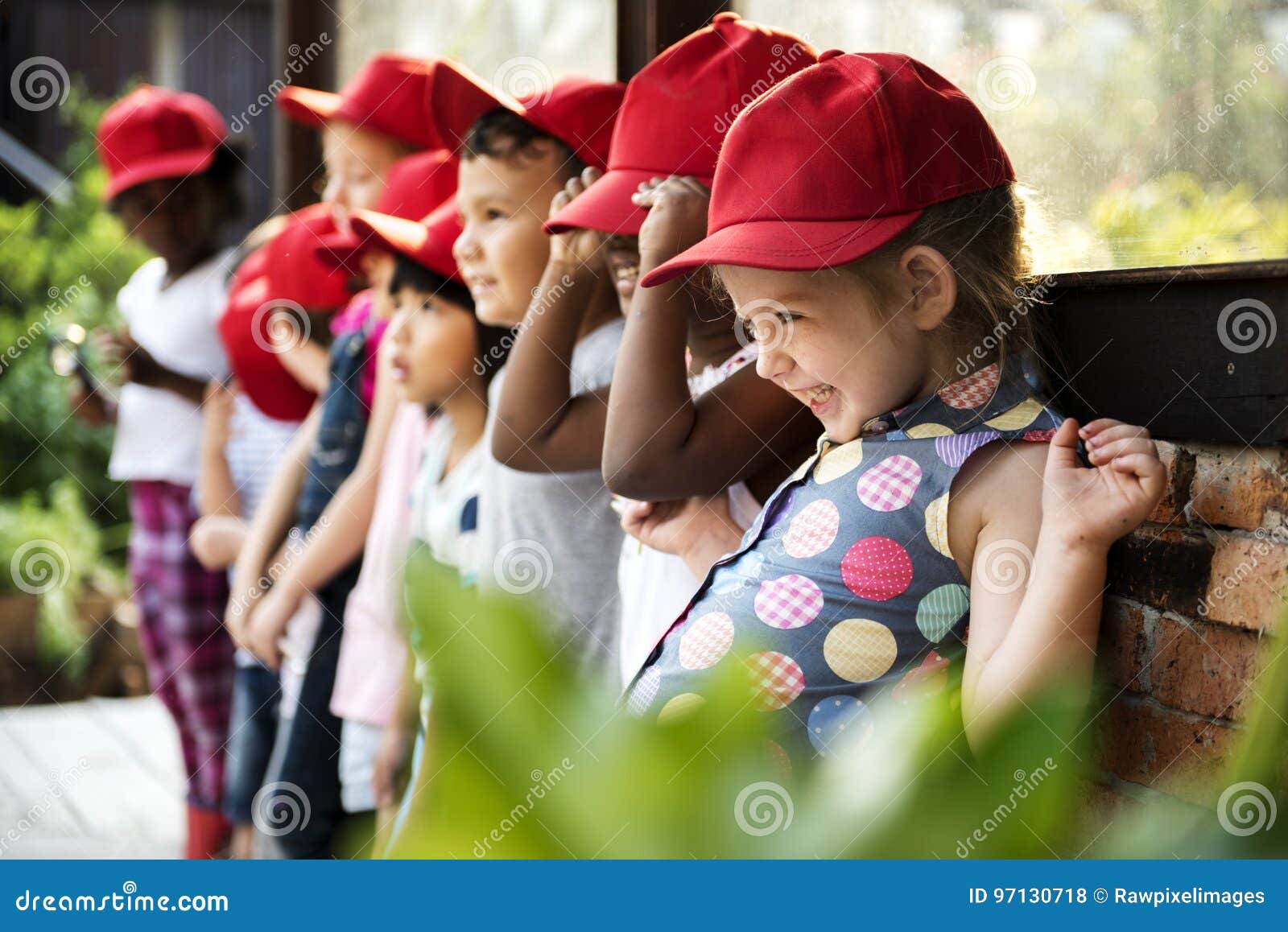 group of kindergarten kids learning gardening outdoors field trips