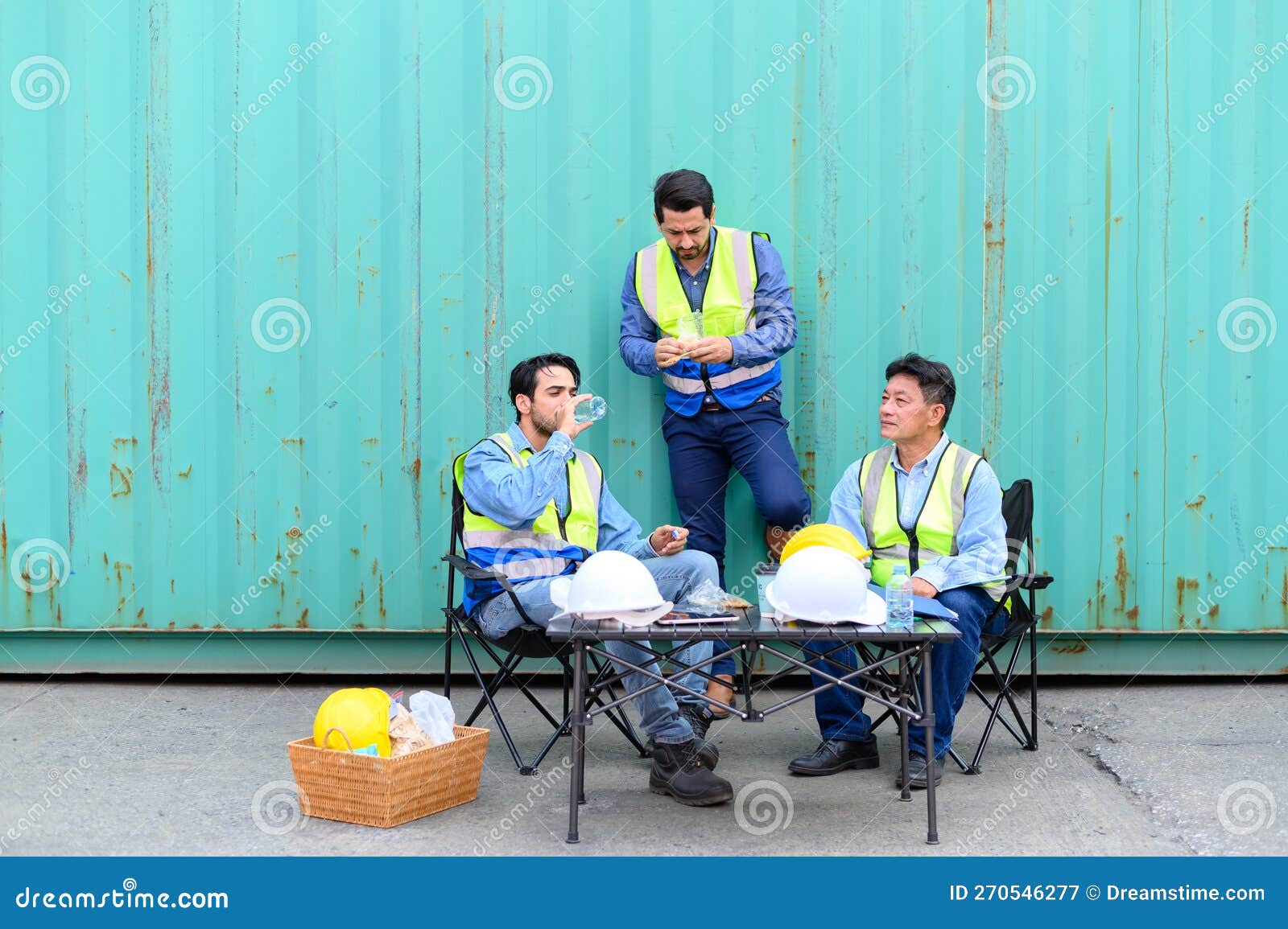 Group of Logistic Staff Workers Talk and Rest Sitting in the Shipping