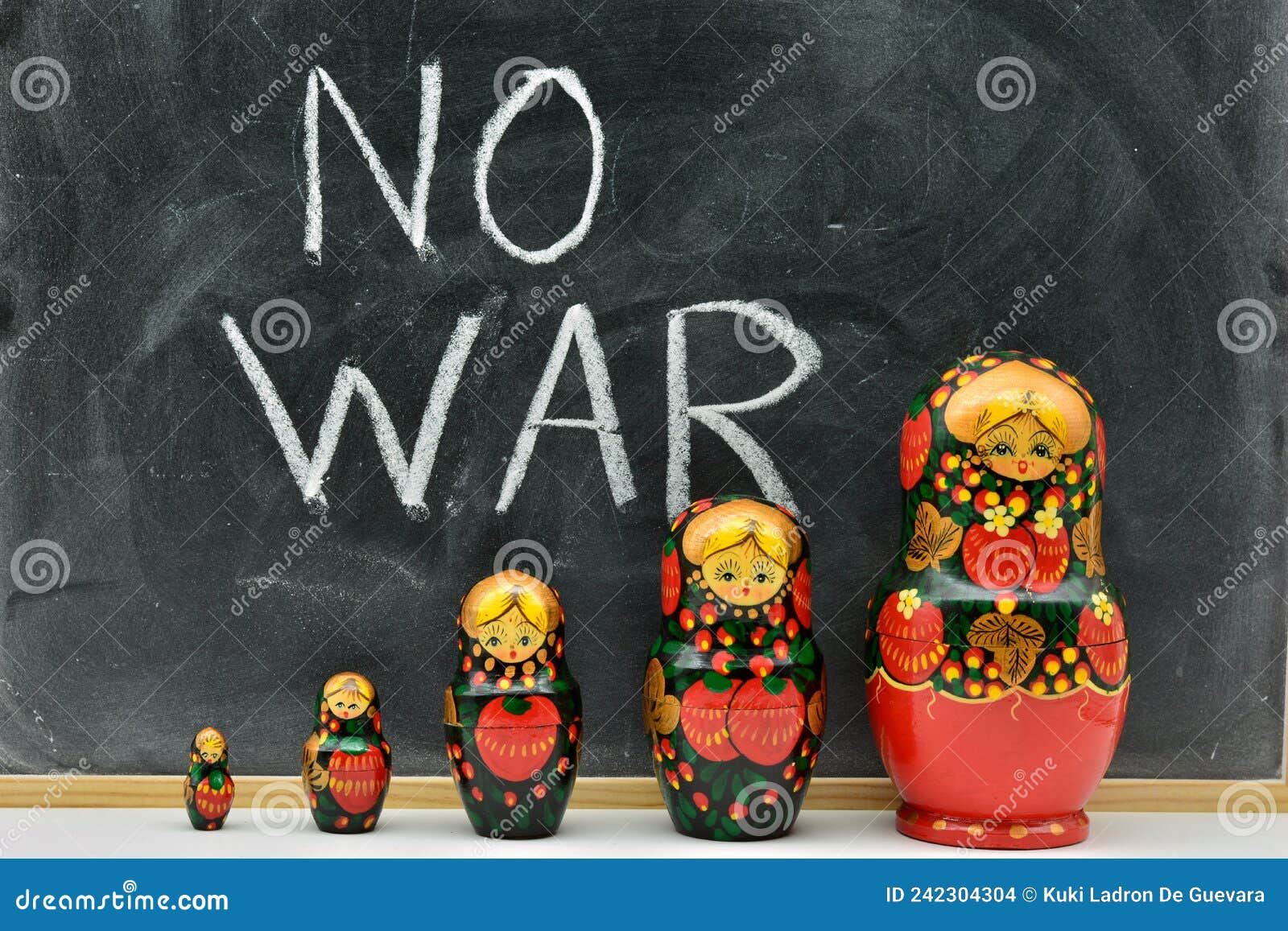 group of matryoshka dolls with the background of a blackboard