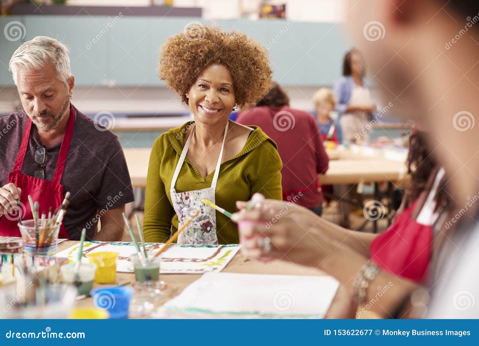 Group of Mature Adults Attending Art Class in Community Centre Stock