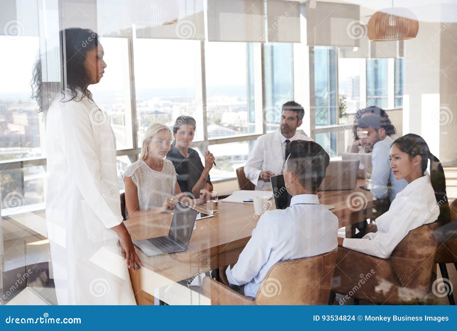 group of medical staff meeting around table in hospital