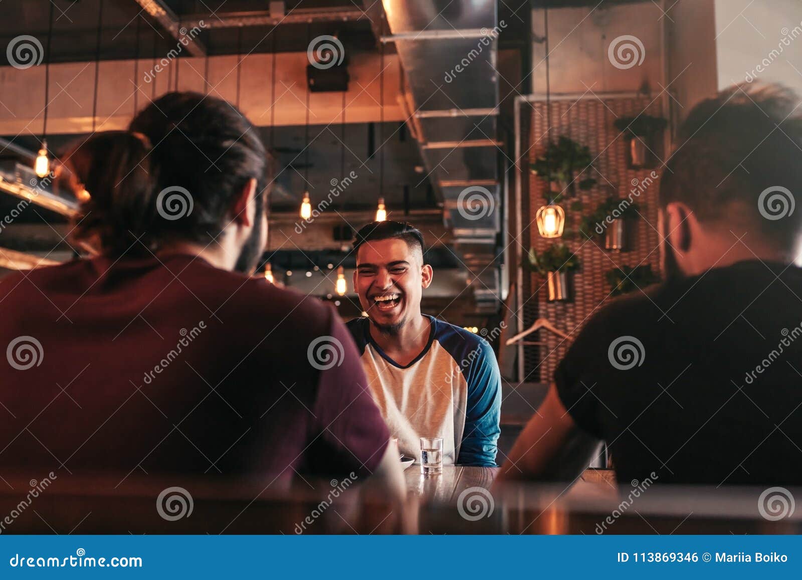 Group of Mixed Race Young Men Talking and Laughing in Lounge Bar ...