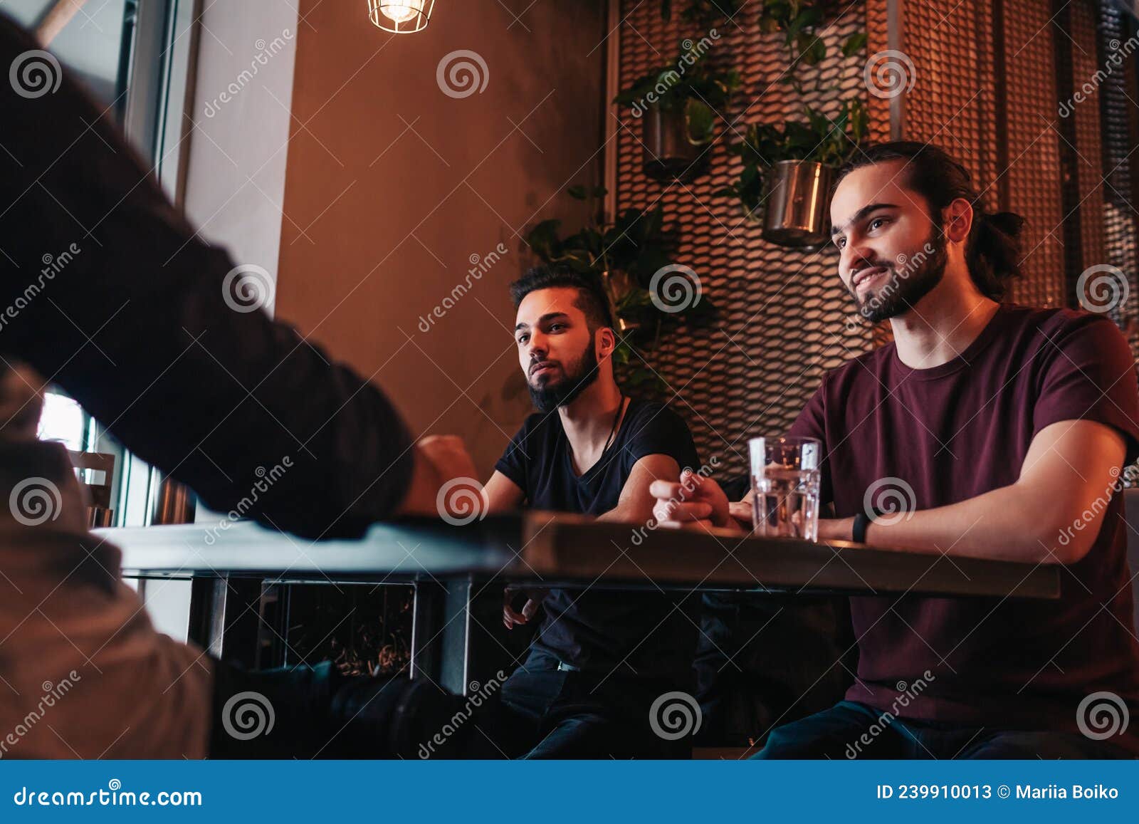 Group of Mixed Race Young Men Talking and Laughing in Lounge Bar ...