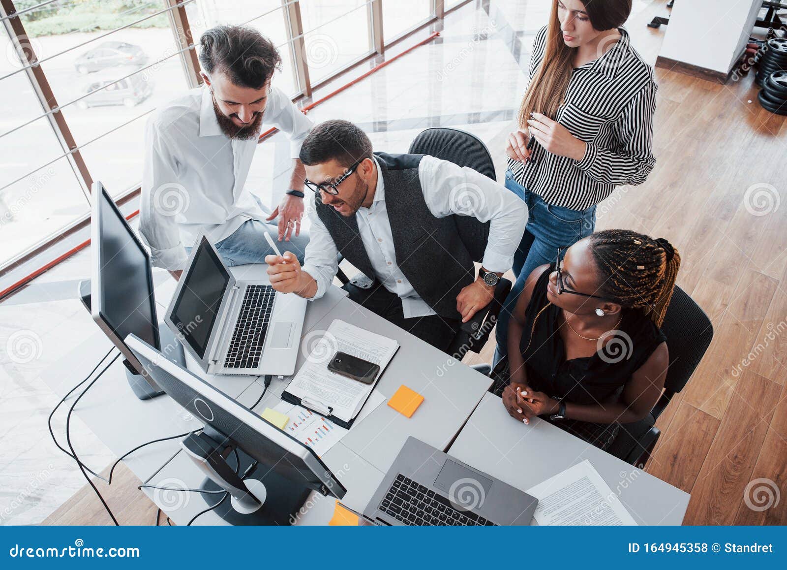 A Group Of Multinational Busy People Working In The Office Stock Photo