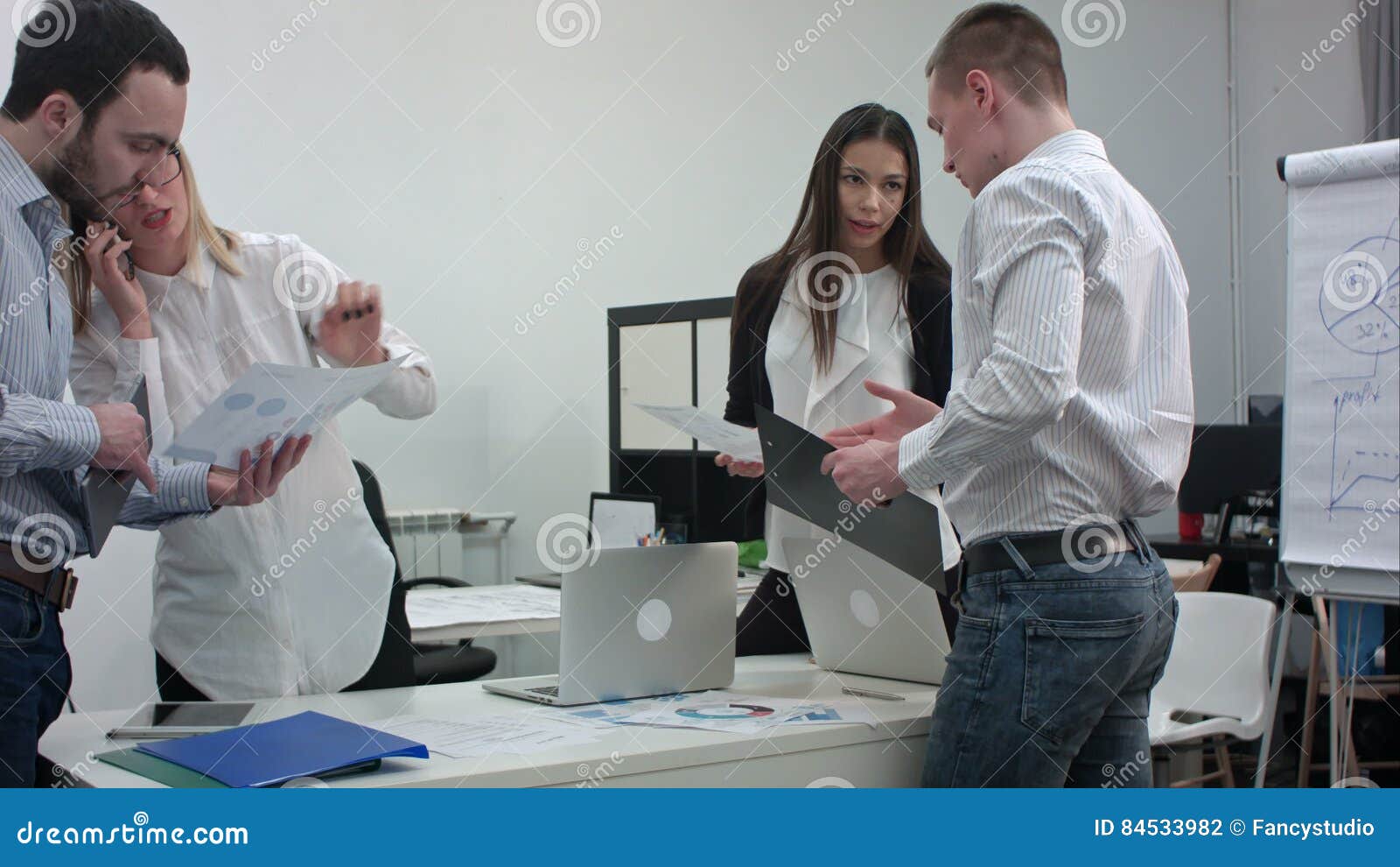 Group Of Office Workers With Diagrams Preparing For Business