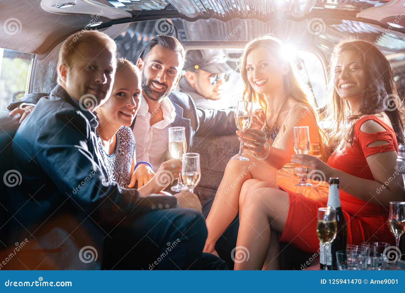 group of party people in a limo drinking