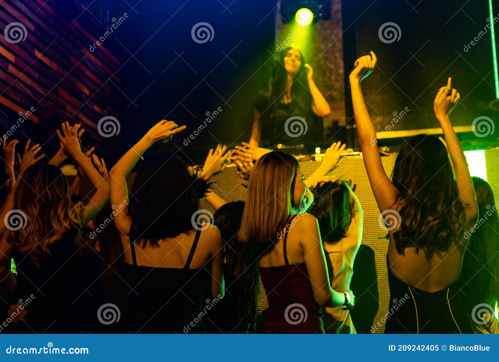 Group of People Dance in Disco Night Club To the Beat of Music from DJ ...