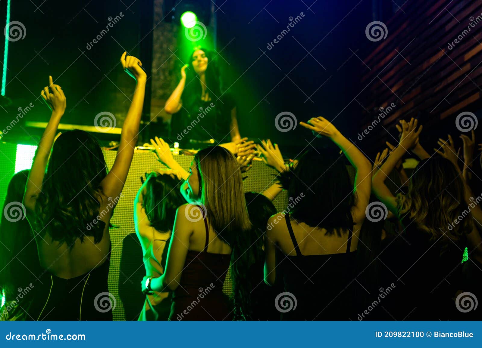 Group of People Dance in Disco Night Club To the Beat of Music from DJ ...