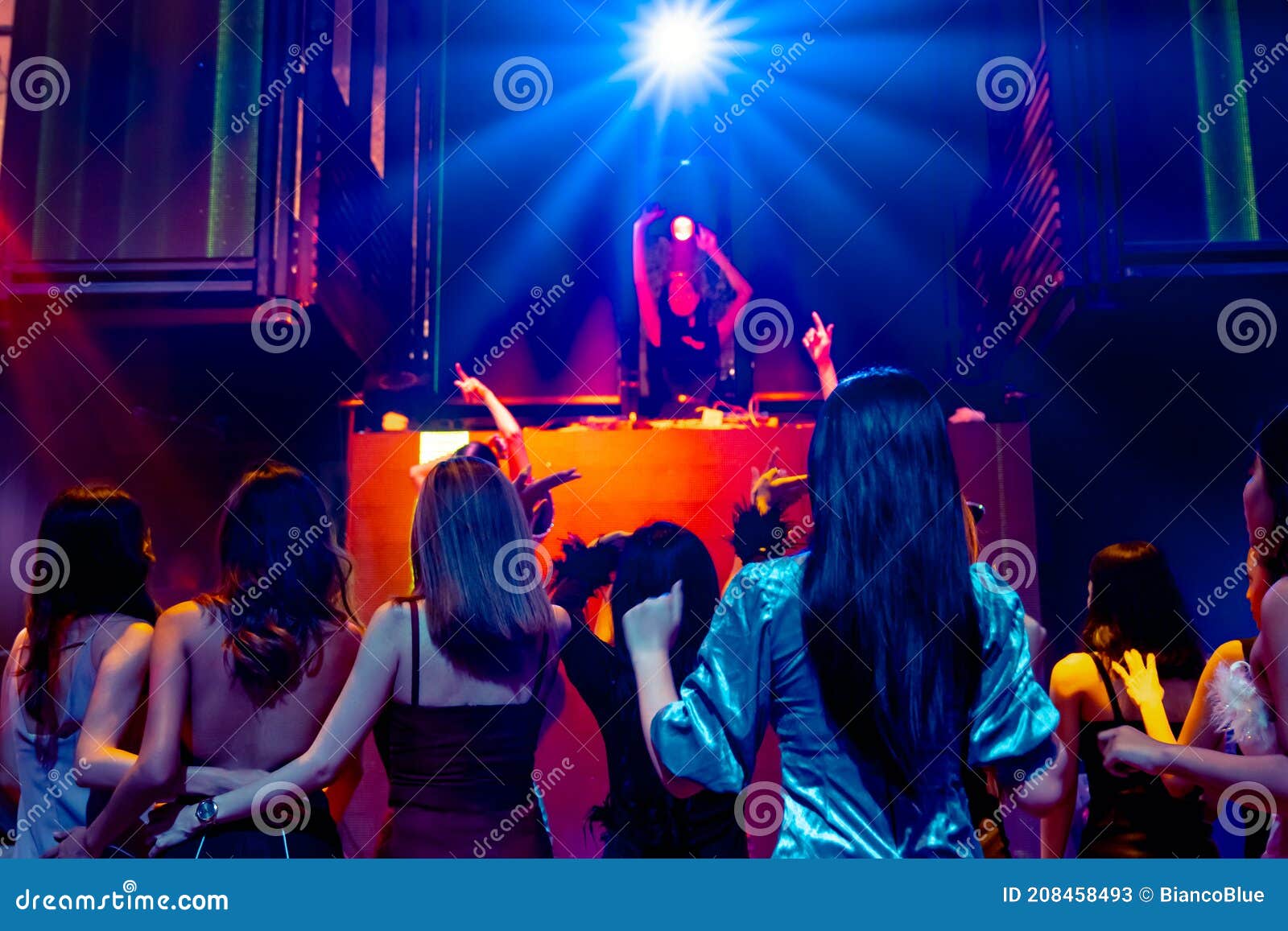 Group of People Dance in Disco Night Club To the Beat of Music from DJ ...