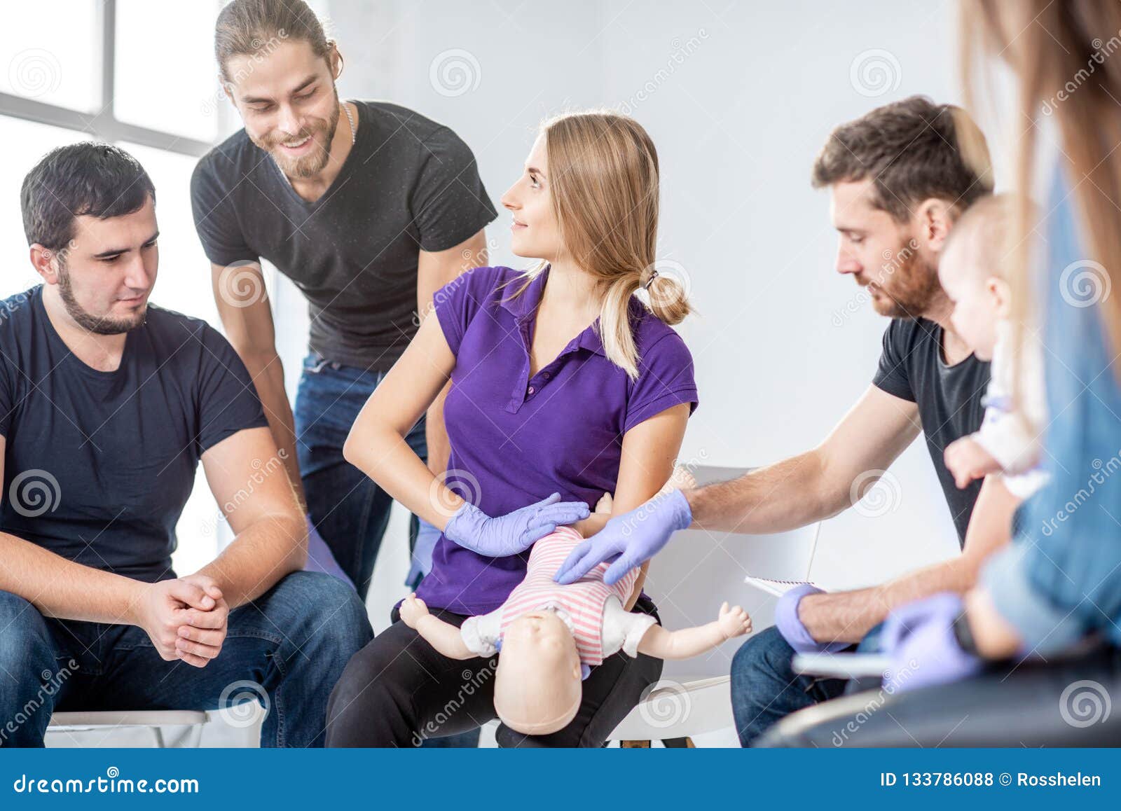 Group of People during the First Aid Training for Baby Stock Photo