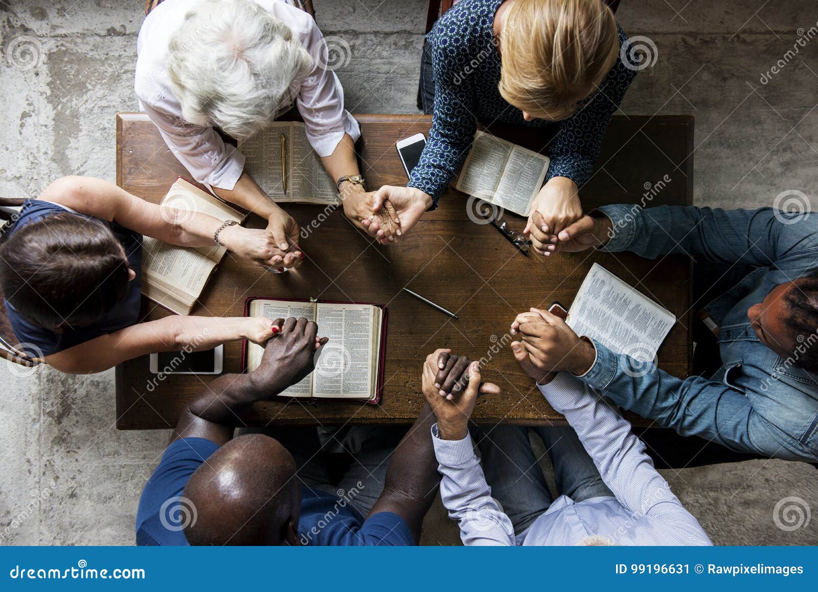 group of people holding hands praying worship believe