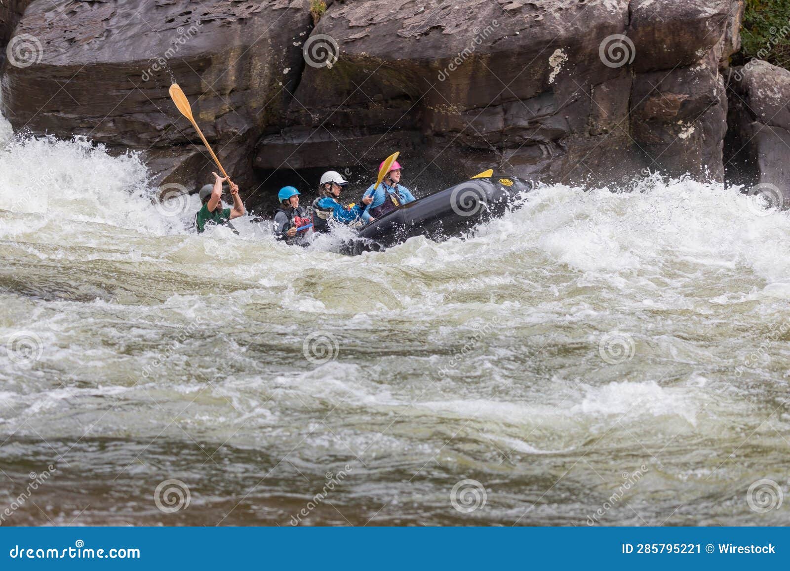 Group of People in a Kayak Navigating through the Choppy Waters of a
