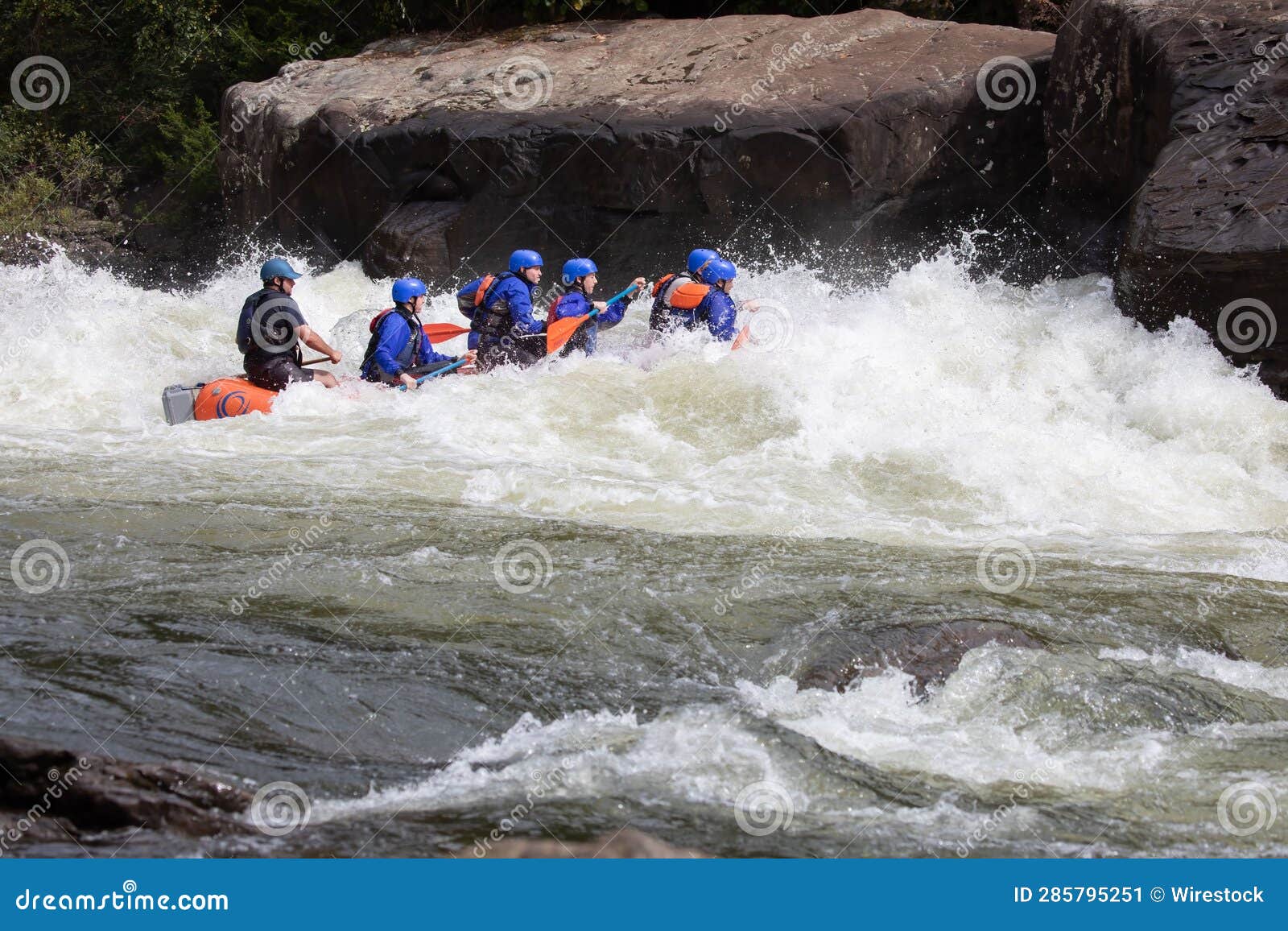 Group of People in a Kayak Navigating through the Choppy Waters of a