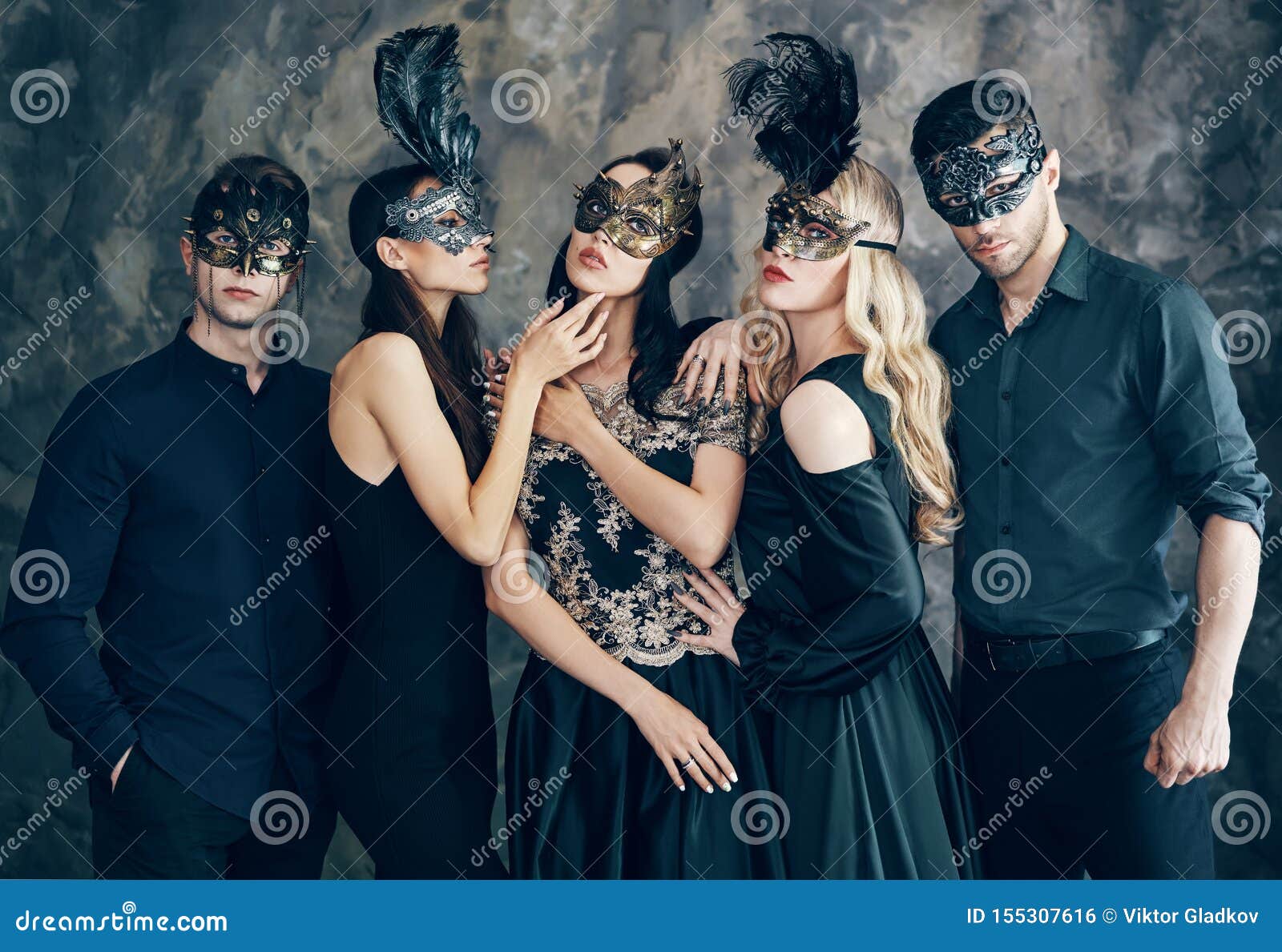Group of People in Masquerade Carnival Mask Posing in Studio Stock