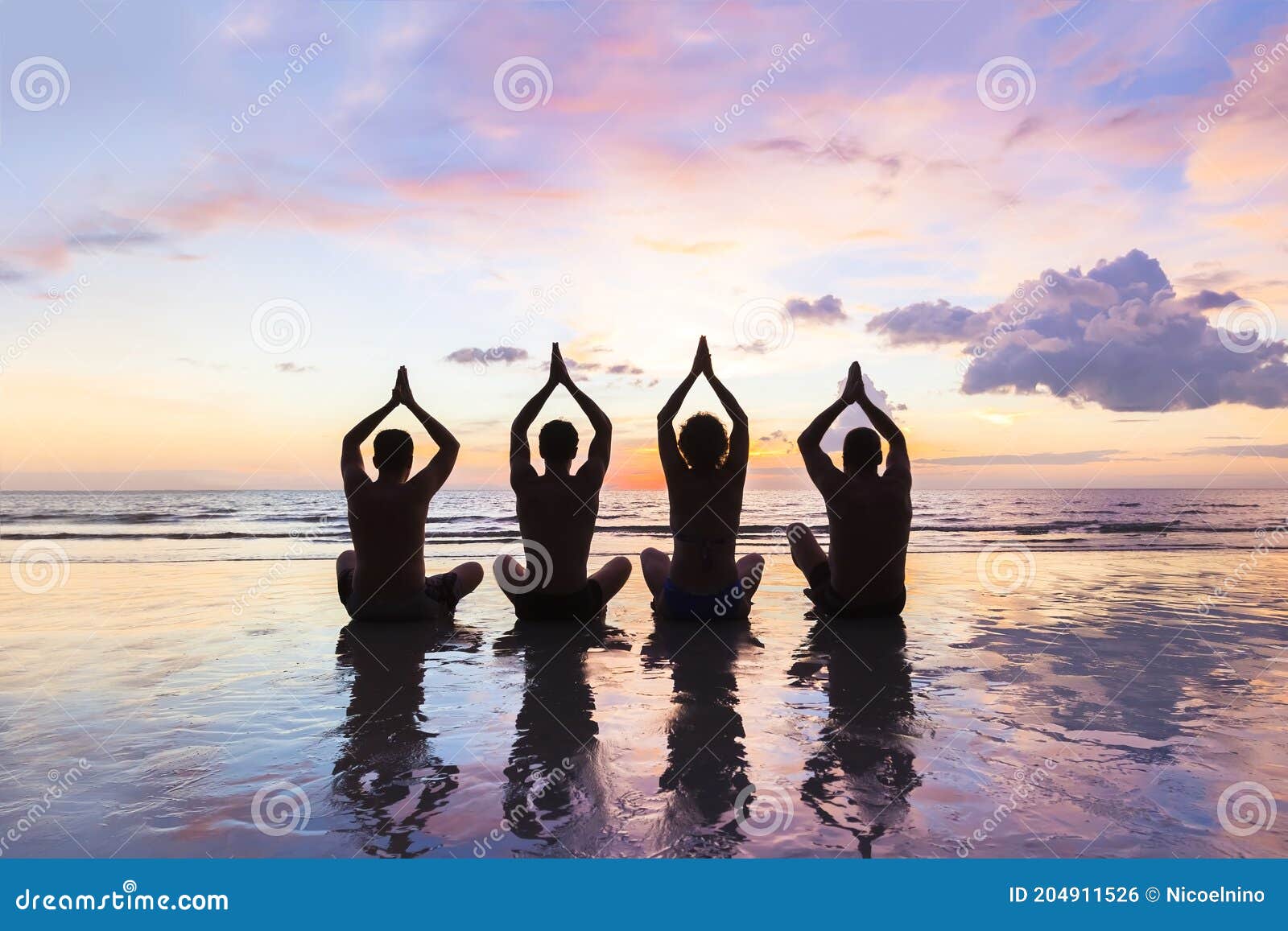 group of people practicing meditation and yoga, beach, sunset, harmony