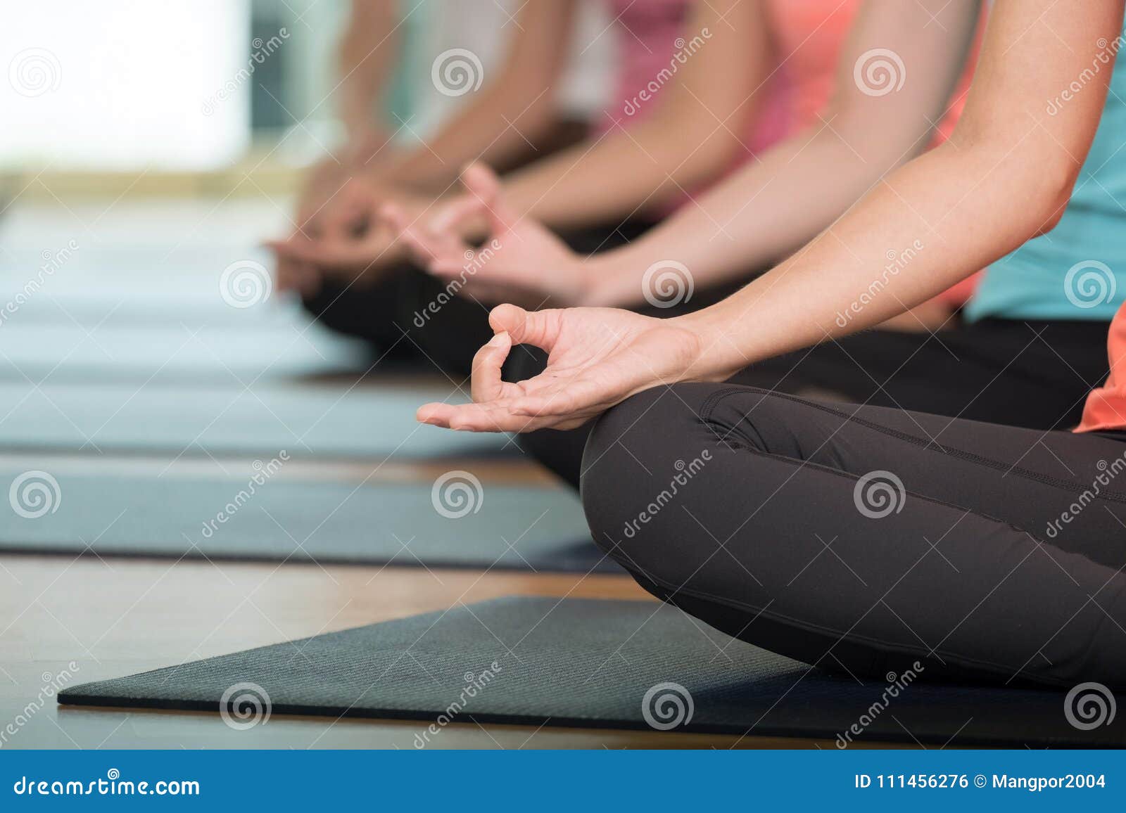 group of people practicing yoga class, hands closeup background, sport and healthy lifestyle, wellness, well being