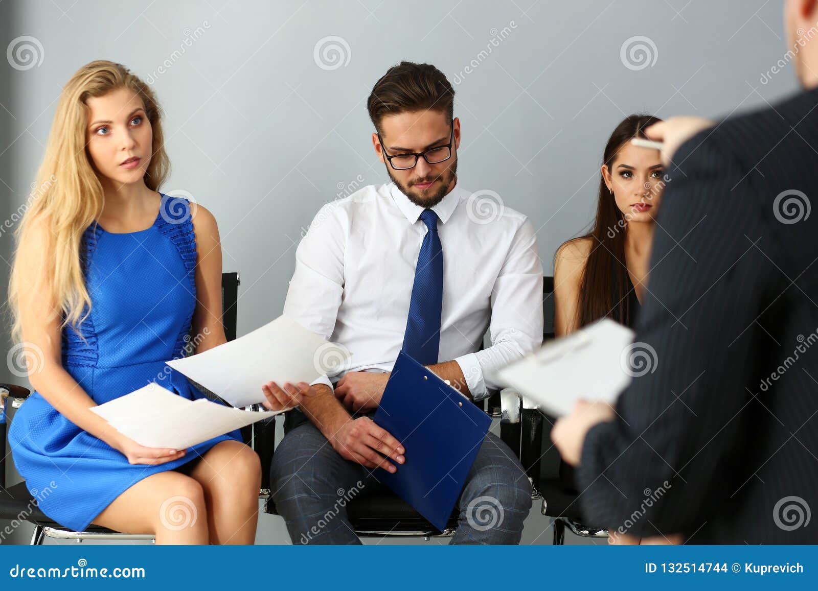 Group of People Sit on Casting Chairs Row at Boss Reception Stock Photo