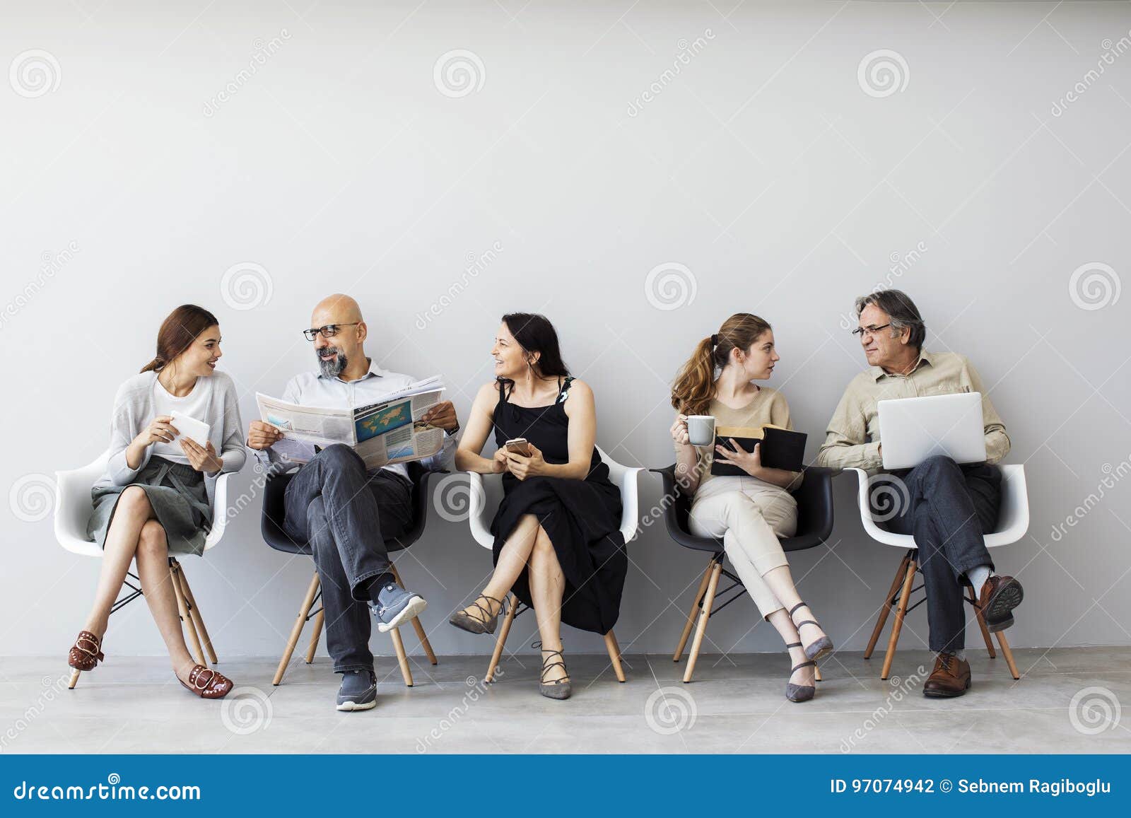 group of people sitting on chairs