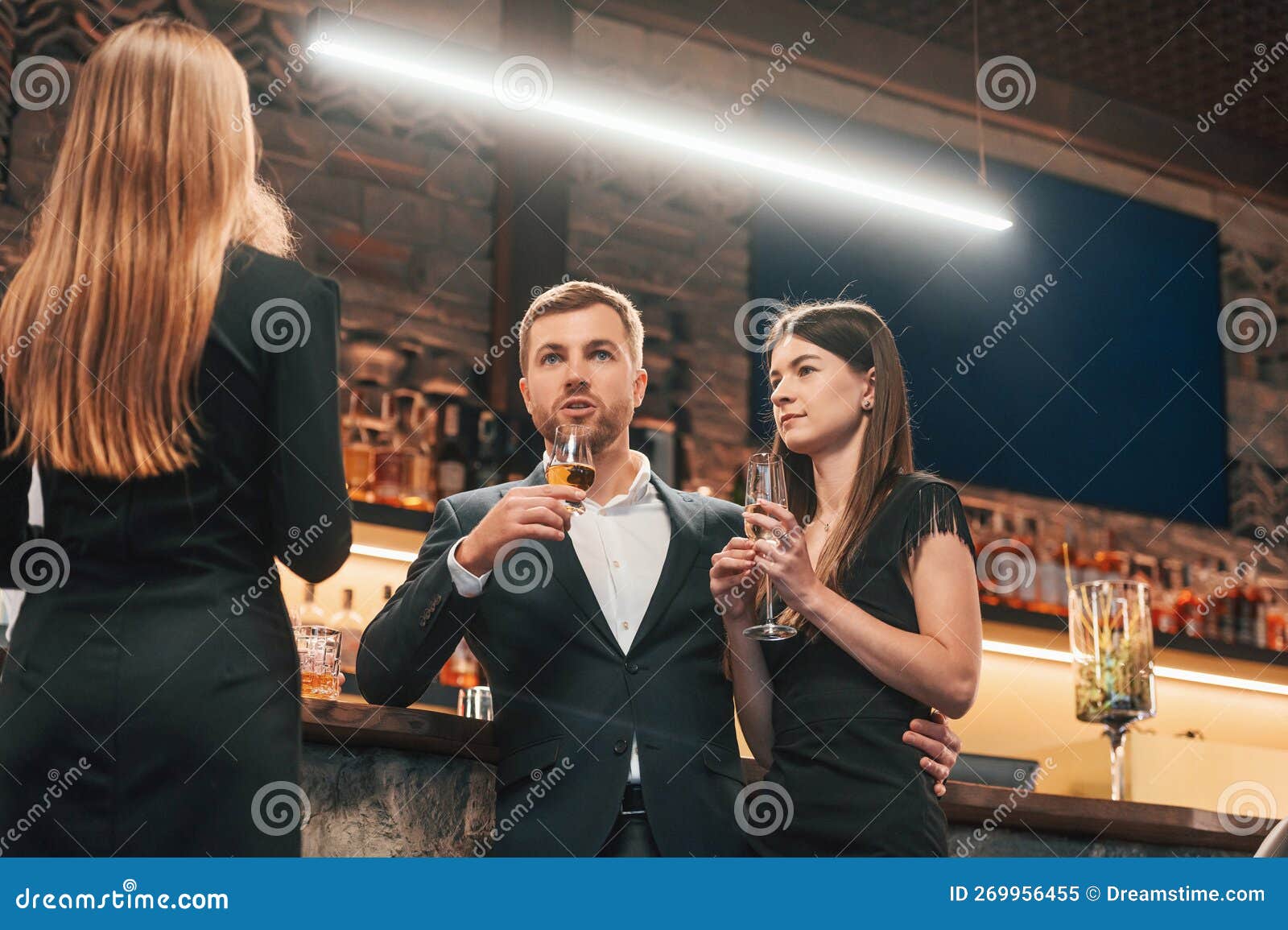 Group of People Standing with Glasses and Celebrating Event Together