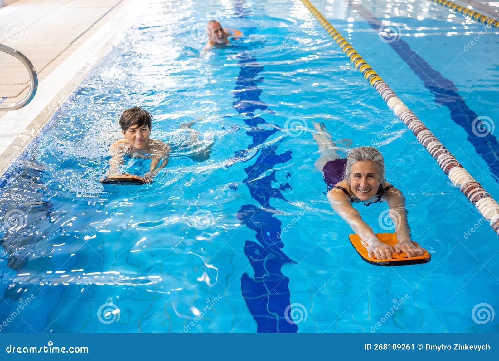 Group of People Swimming in the Swimming Pool and Looking Enjoyed Stock