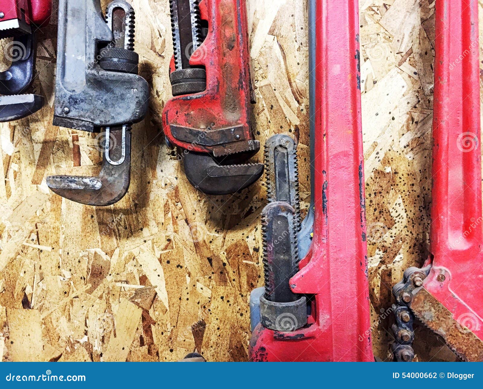 Group of Pipe Wrenches Hanging on Wooden Wall. Stock Photo Image of
