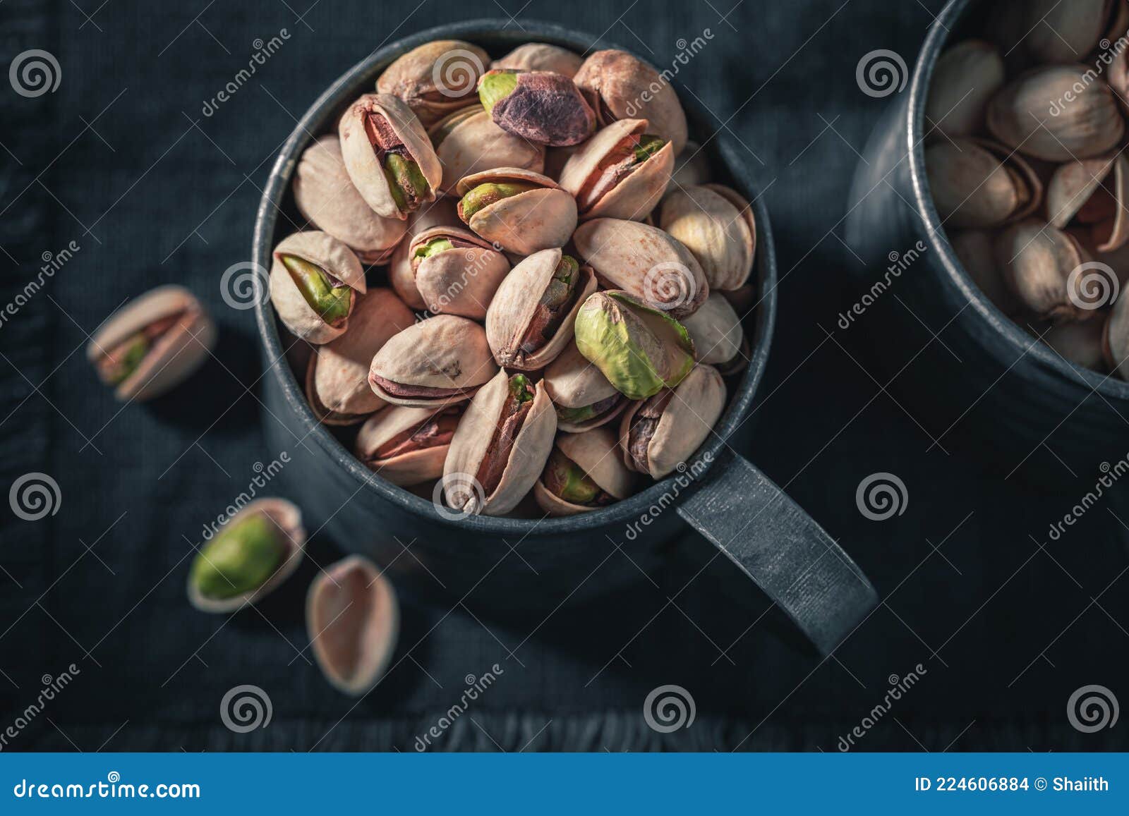 Group of Pistachios on Dark Table. Quick and Good Snack Stock Photo