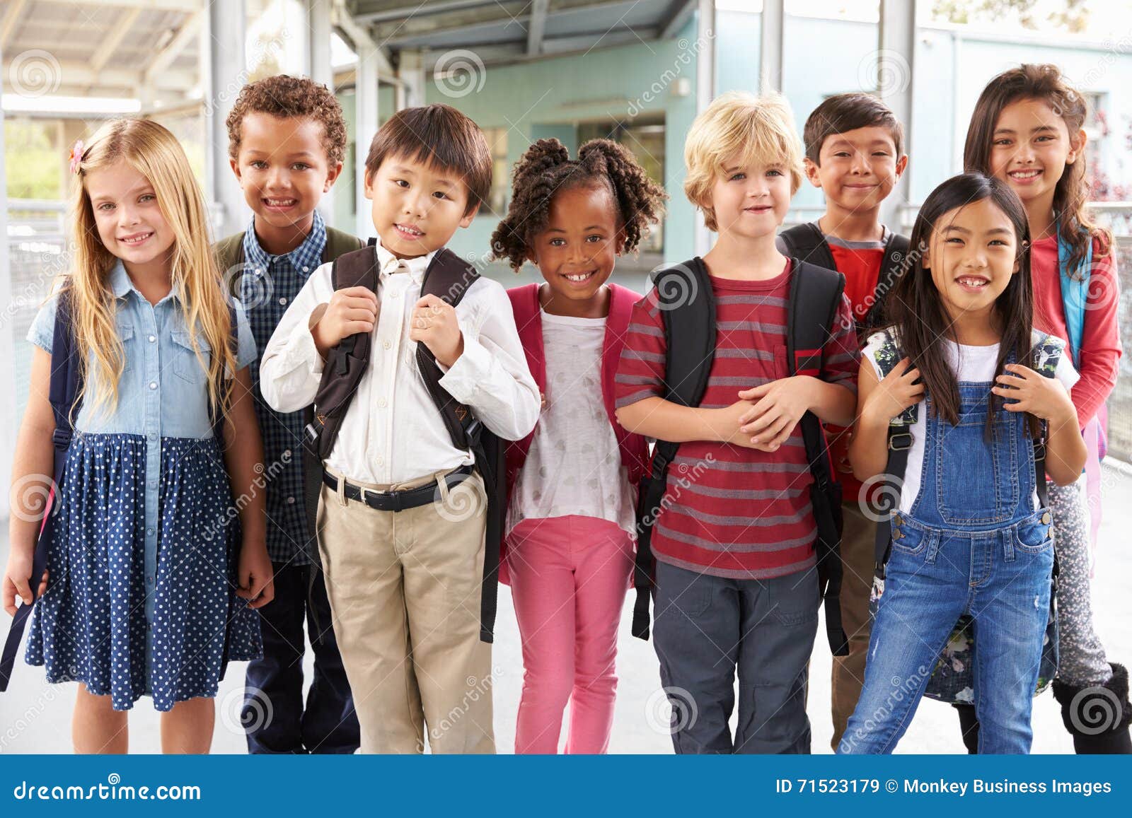 group portrait of ary school kids in school corridor