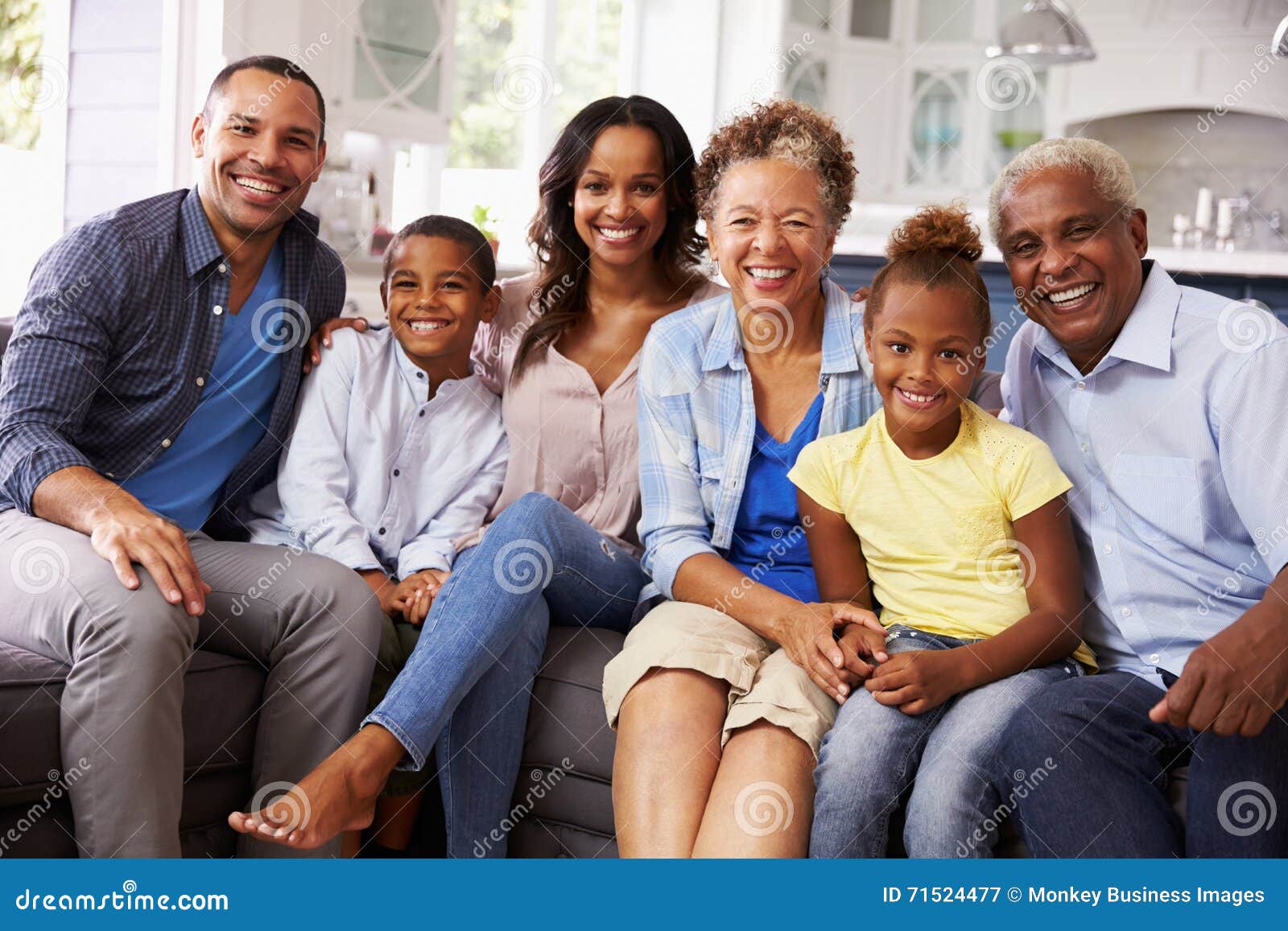 group portrait of multi generation black family at home