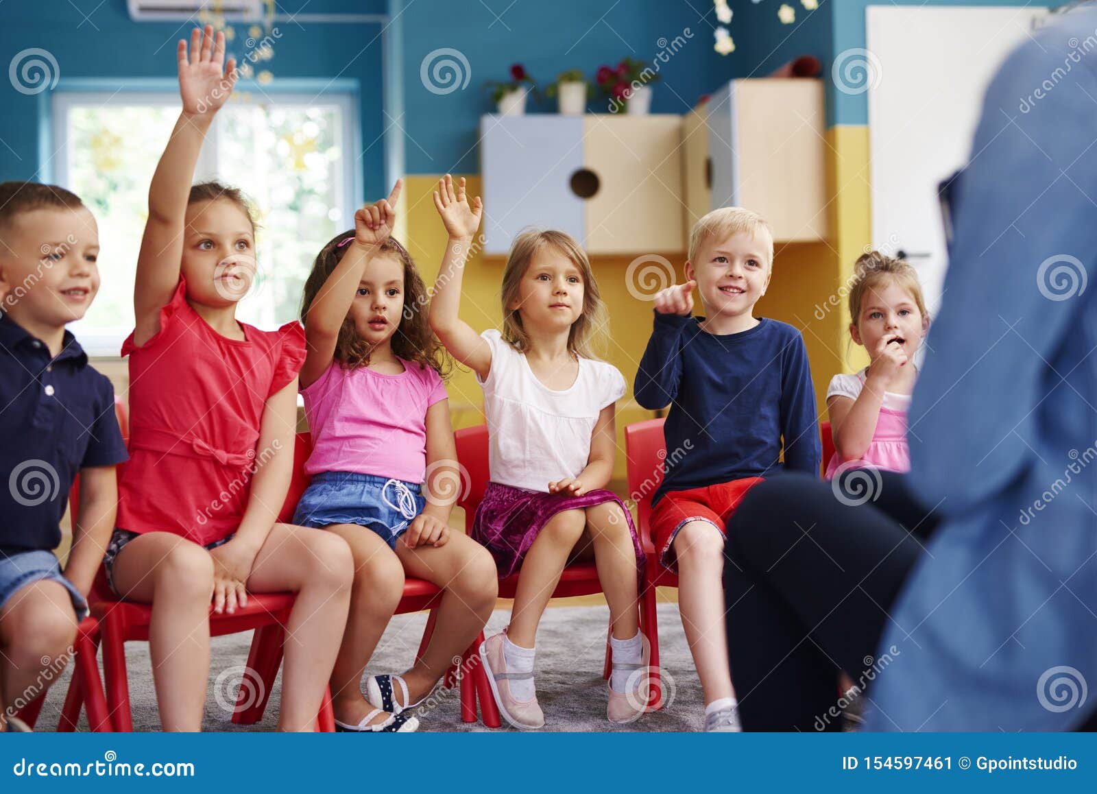 Group Of Preschool Children Answering A Question Stock
