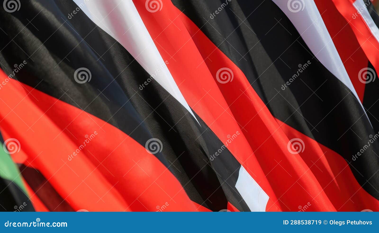 A Group of Red, Black, and Green Flags with a White Star on Top of One