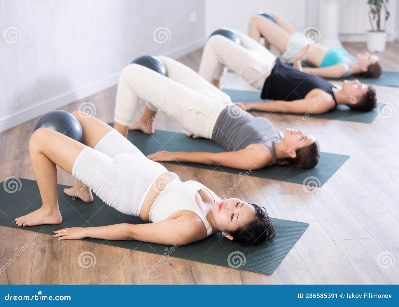 Young People Doing Softball Pilates in Studio. Stock Image - Image