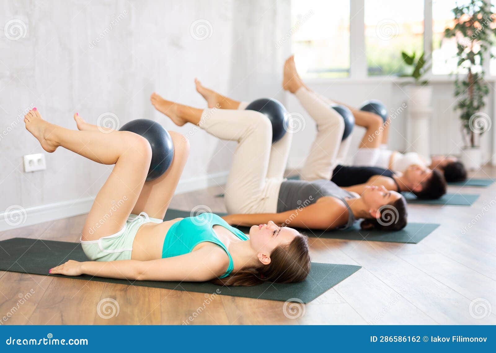 Young People Doing Softball Pilates in Studio. Stock Photo - Image