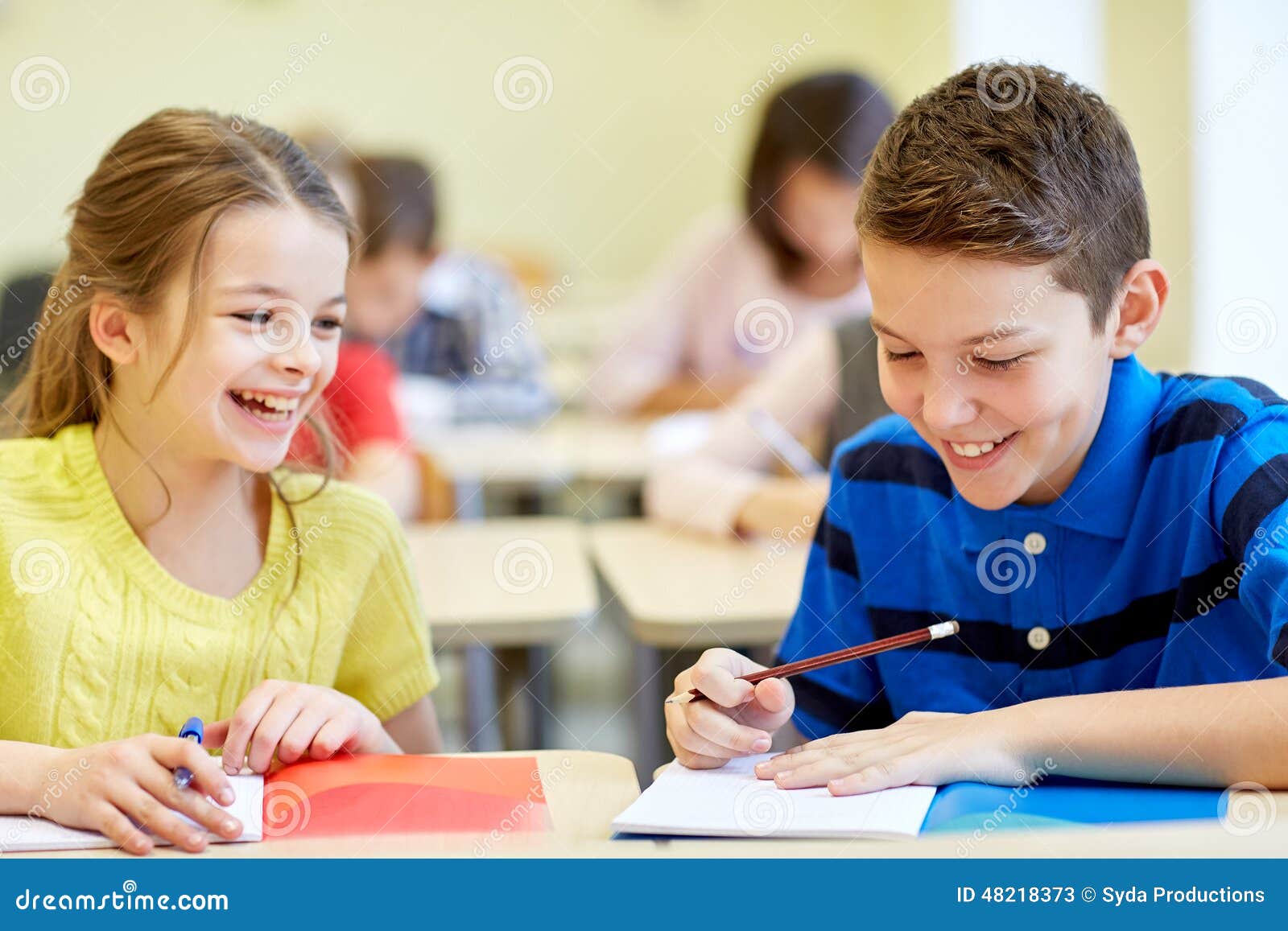 El Companero De Clase In English Group of School Kids Writing Test in Classroom Stock Image - Image of