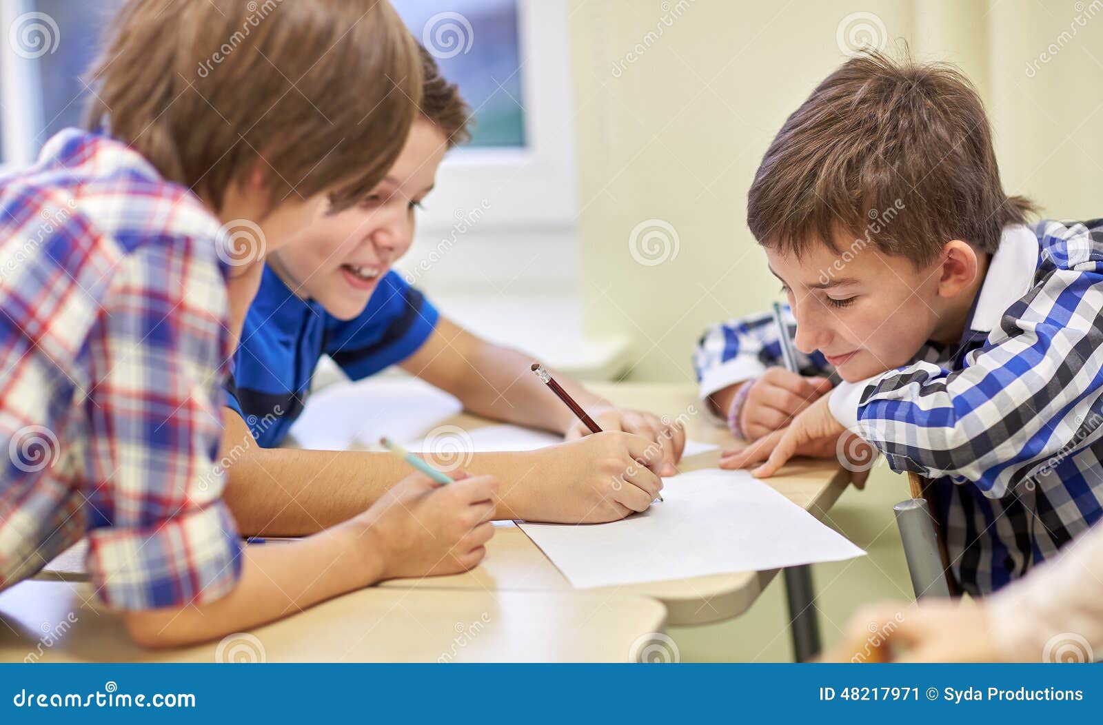 group of schoolboys writing or drawing at school