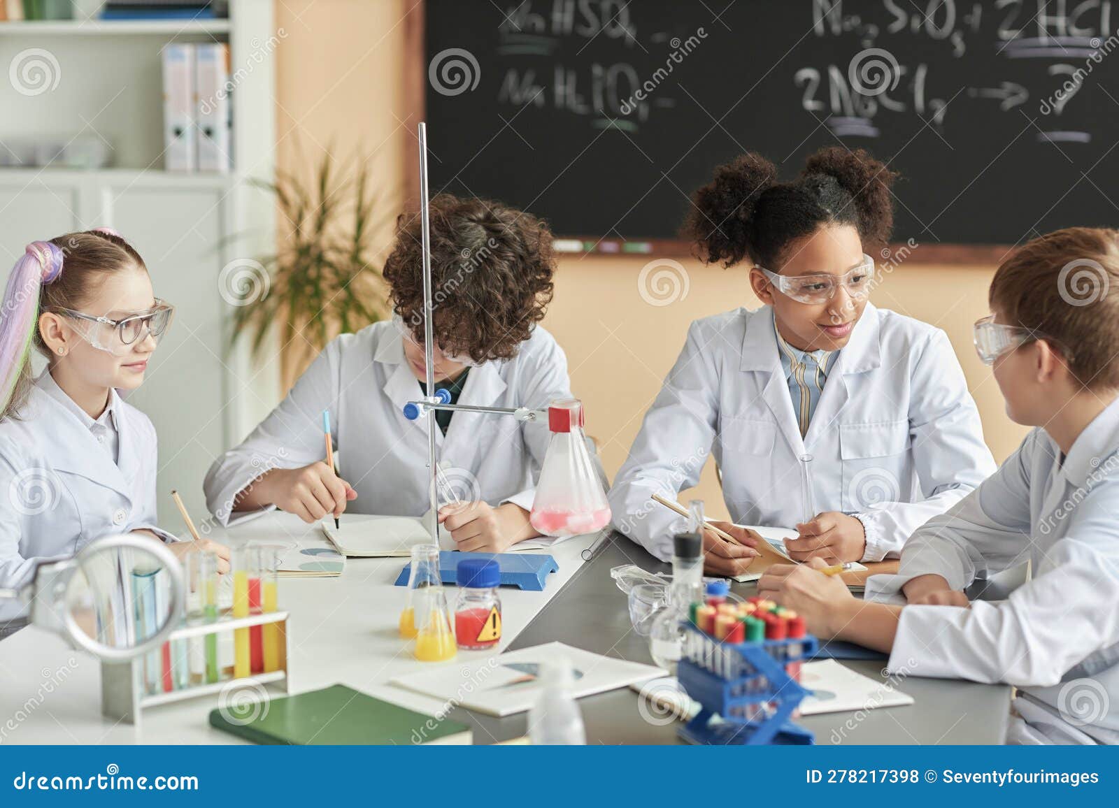 Group of Schoolchildren Wearing Lab Coats during Science Experiment