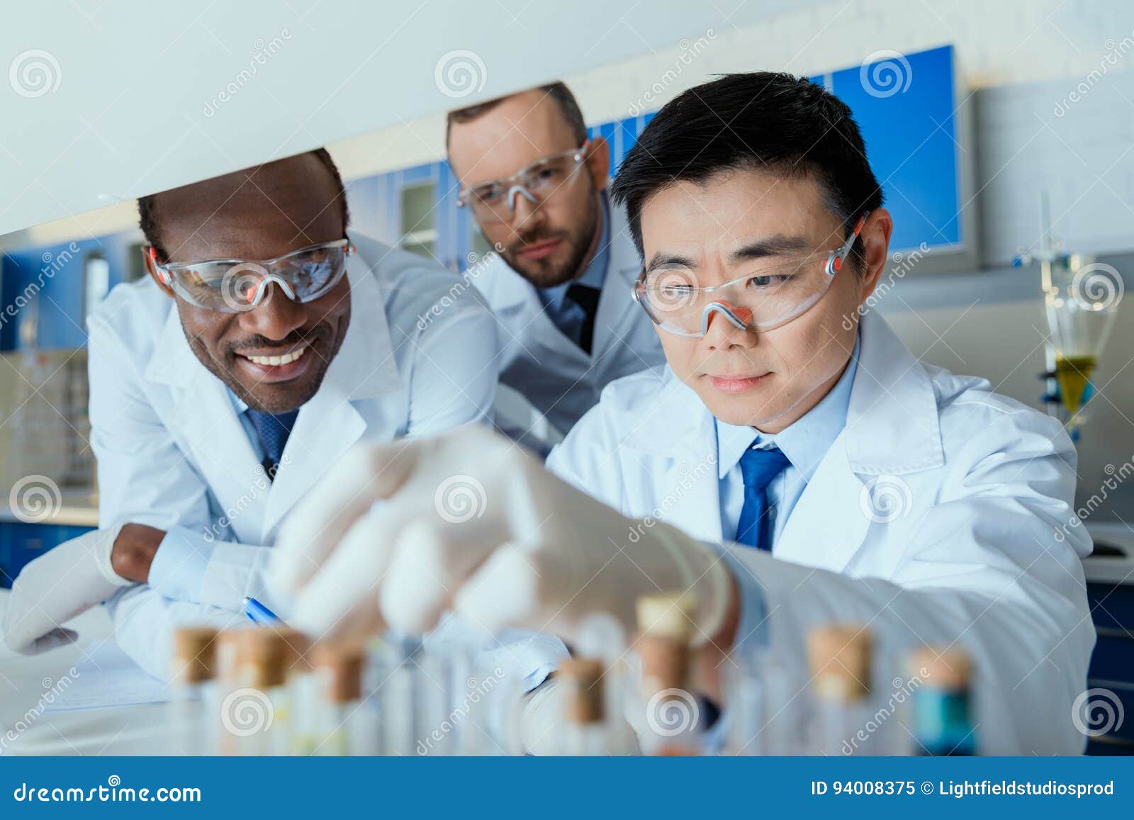 Group of Scientists in Protective Eyeglasses Working Together in